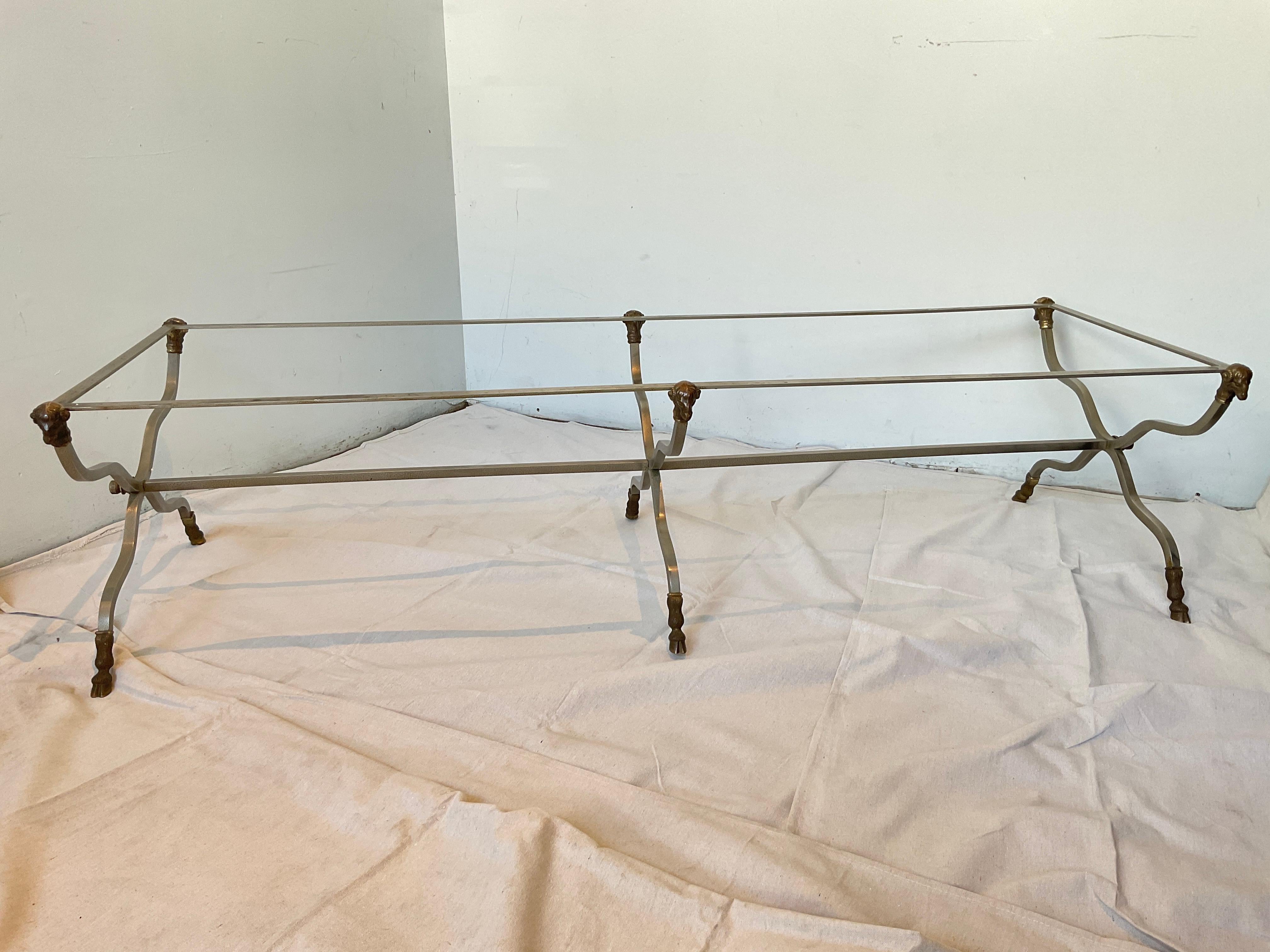 Italian Maison Jansen style steel / brass ram head coffee table . Very long. Can also be made into a bench. Some spots of rust as shown in pictures.
There is no glass.