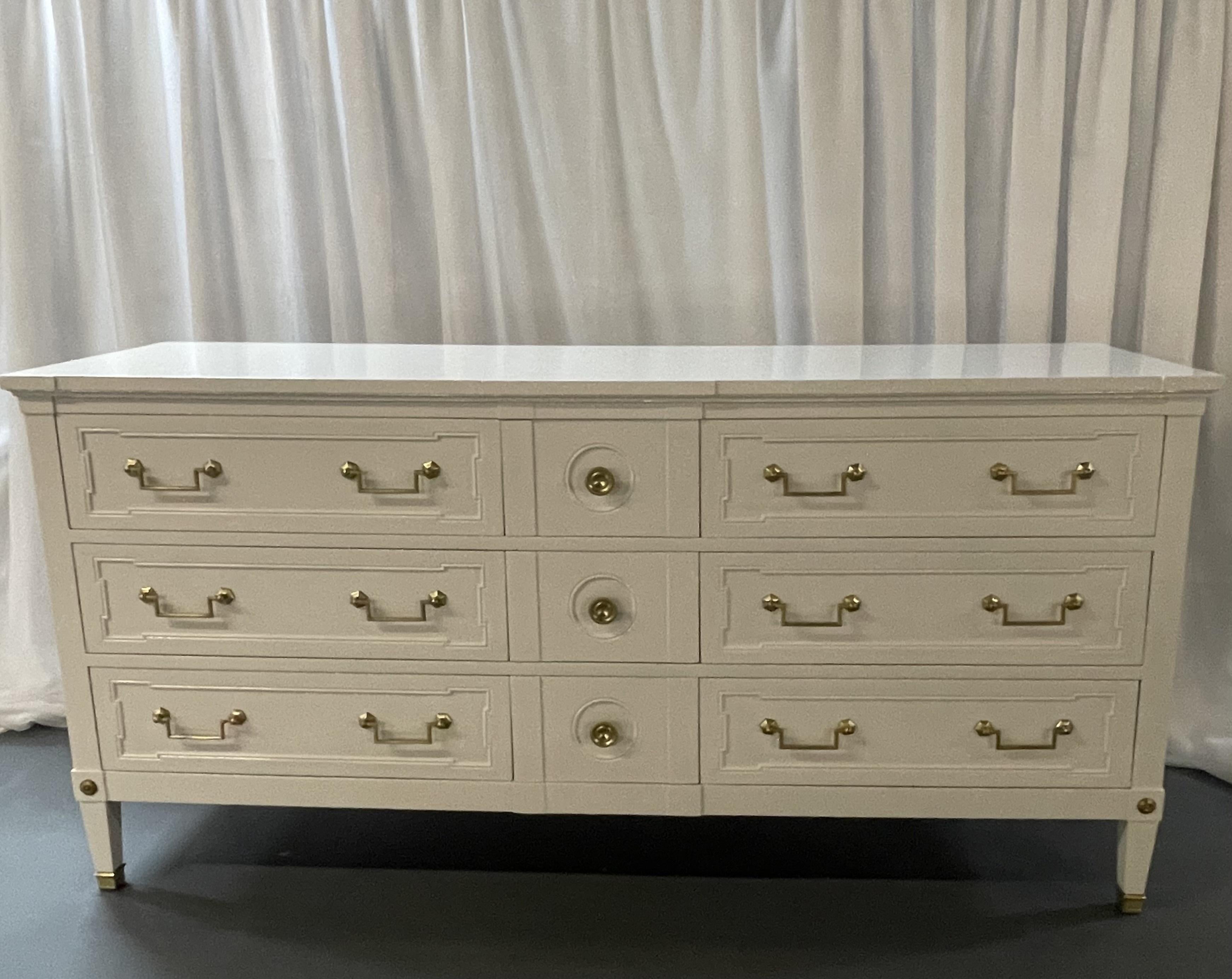 Maison Jansen Style Mid Century Modern Dresser or Sideboard, White Lacquer
A fully refinished white lacquered bronze mounted dresser in the manner of Maison Jansen. Having three center drawers flanked by three larger drawers all with bronze draw a