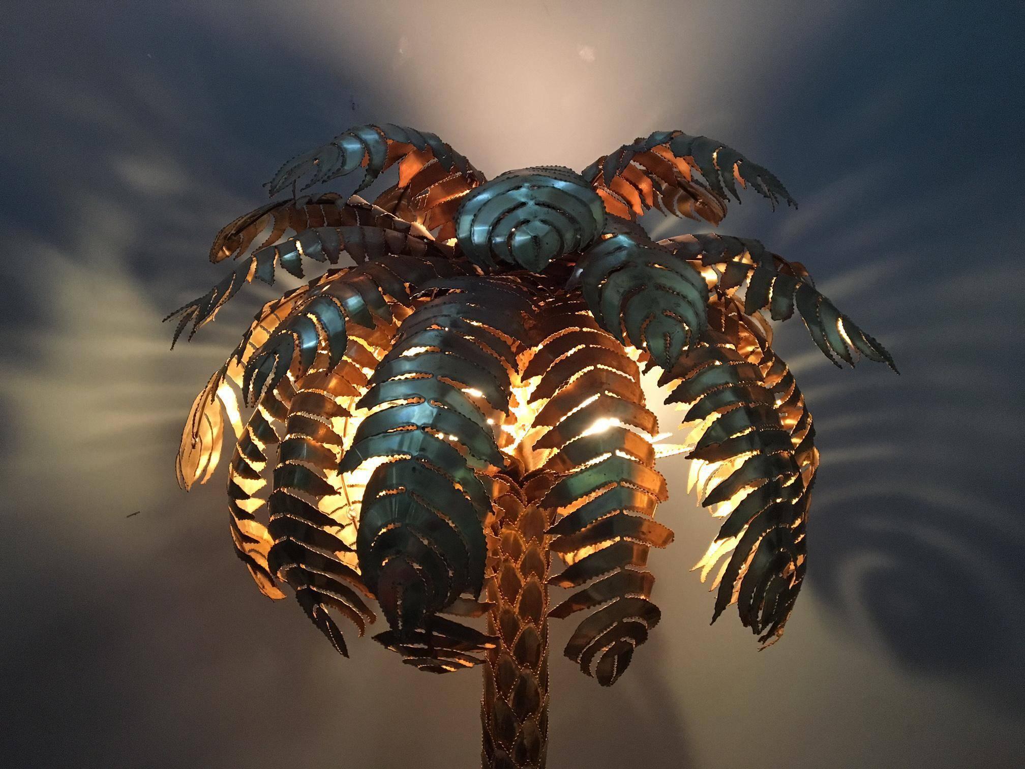 Large sculptural brass palm tree sculpture doubles as a floor lamp and will compliment any Hollywood Regency decor. Beautiful brass finish and mounted in a heavy base, this tree stands almost 6 feet tall. Takes four standard light bulbs. Excellent
