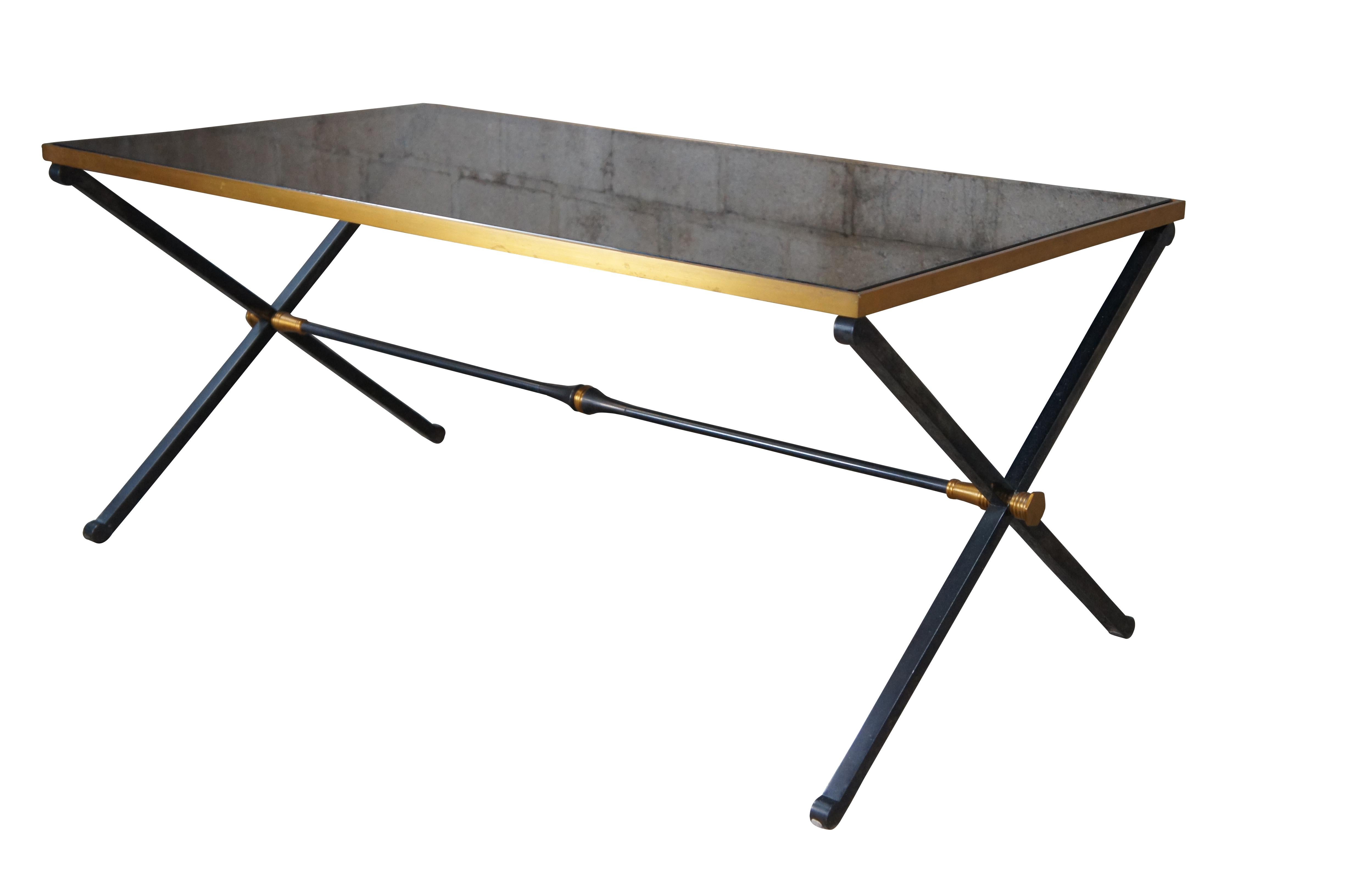 Maison Jansen style Neoclassical modern cocktail table. Made from steel with a black and gold X form base with smoked glass polished edge top. The X frame is connected by cylindrical trestle flared like a trumpet at the center.

Dimensions:
22