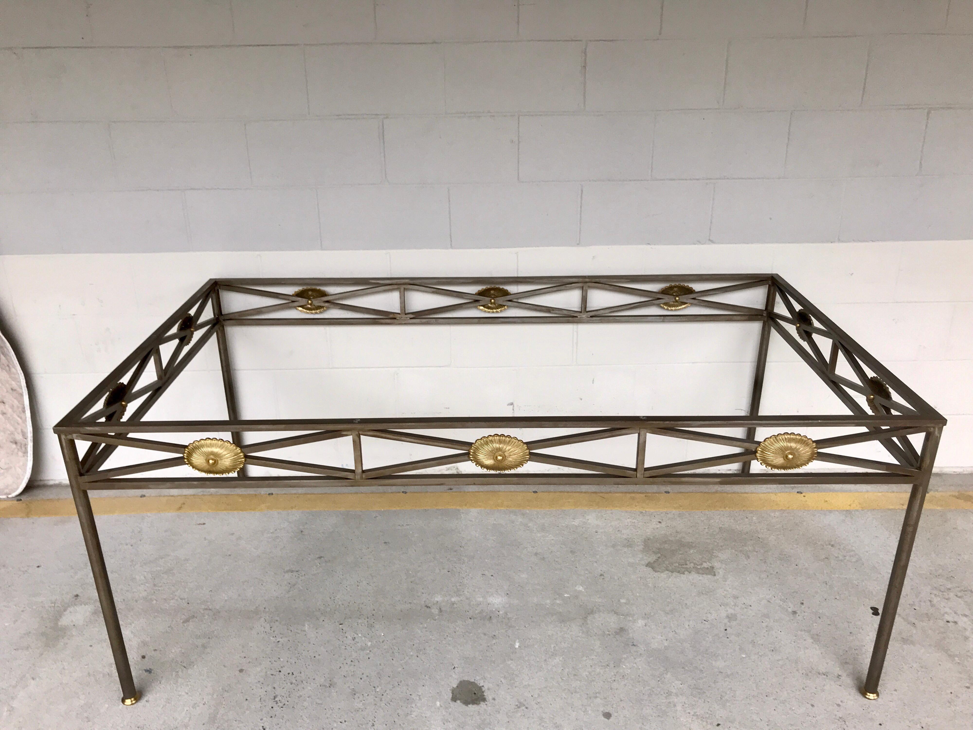 Maison Jansen style neoclassical steel and bronze dining table base. Of rectangular form with brushed steel and gilt bronze rosettes, raised on four bronze sabot fitted legs. This base does not include a top. The base measures 70.5