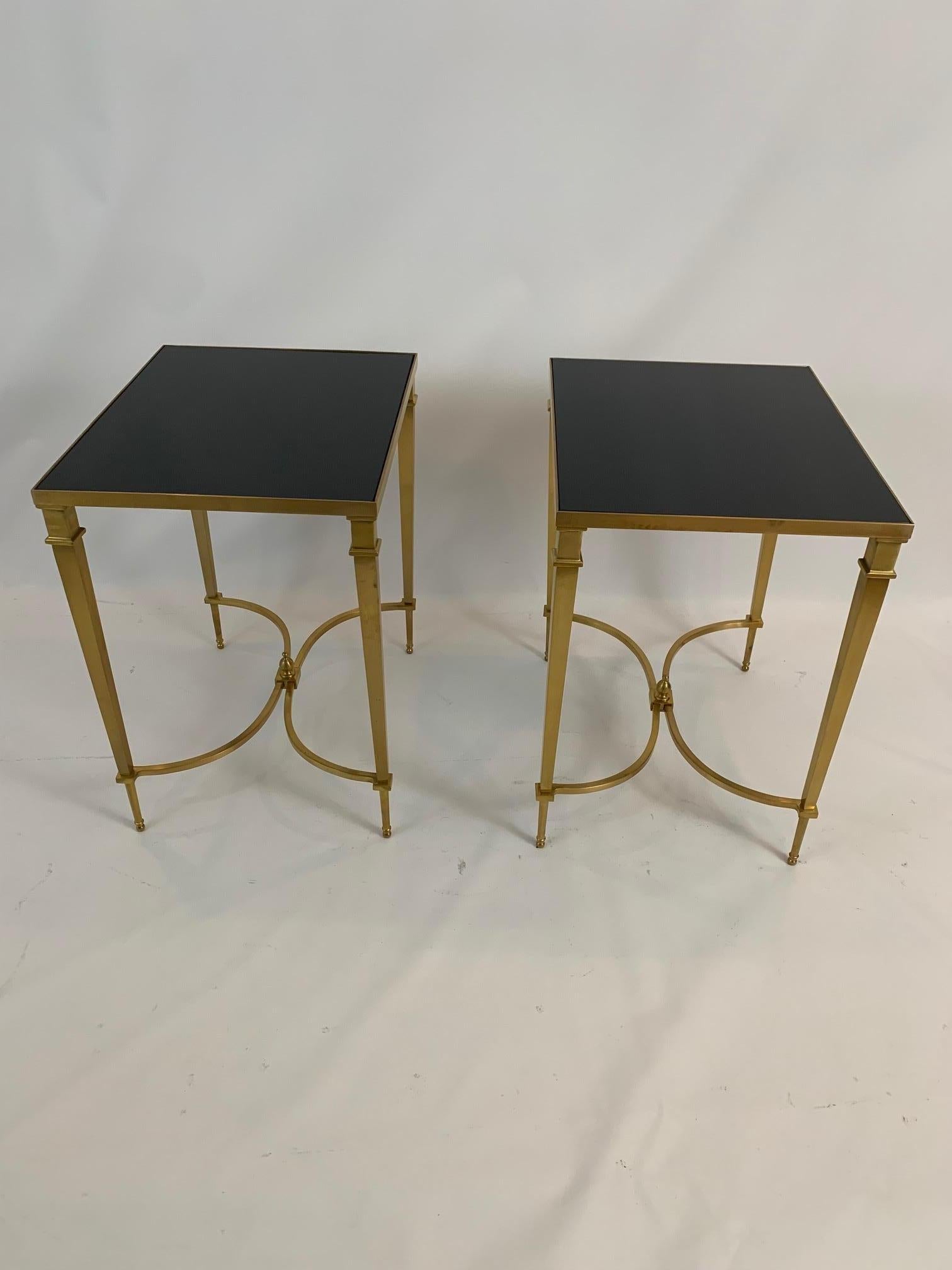 Very elegant sophisticated pair of French Maison Jansen style end tables having square leg brass bases and contrasting black granite tops.

 