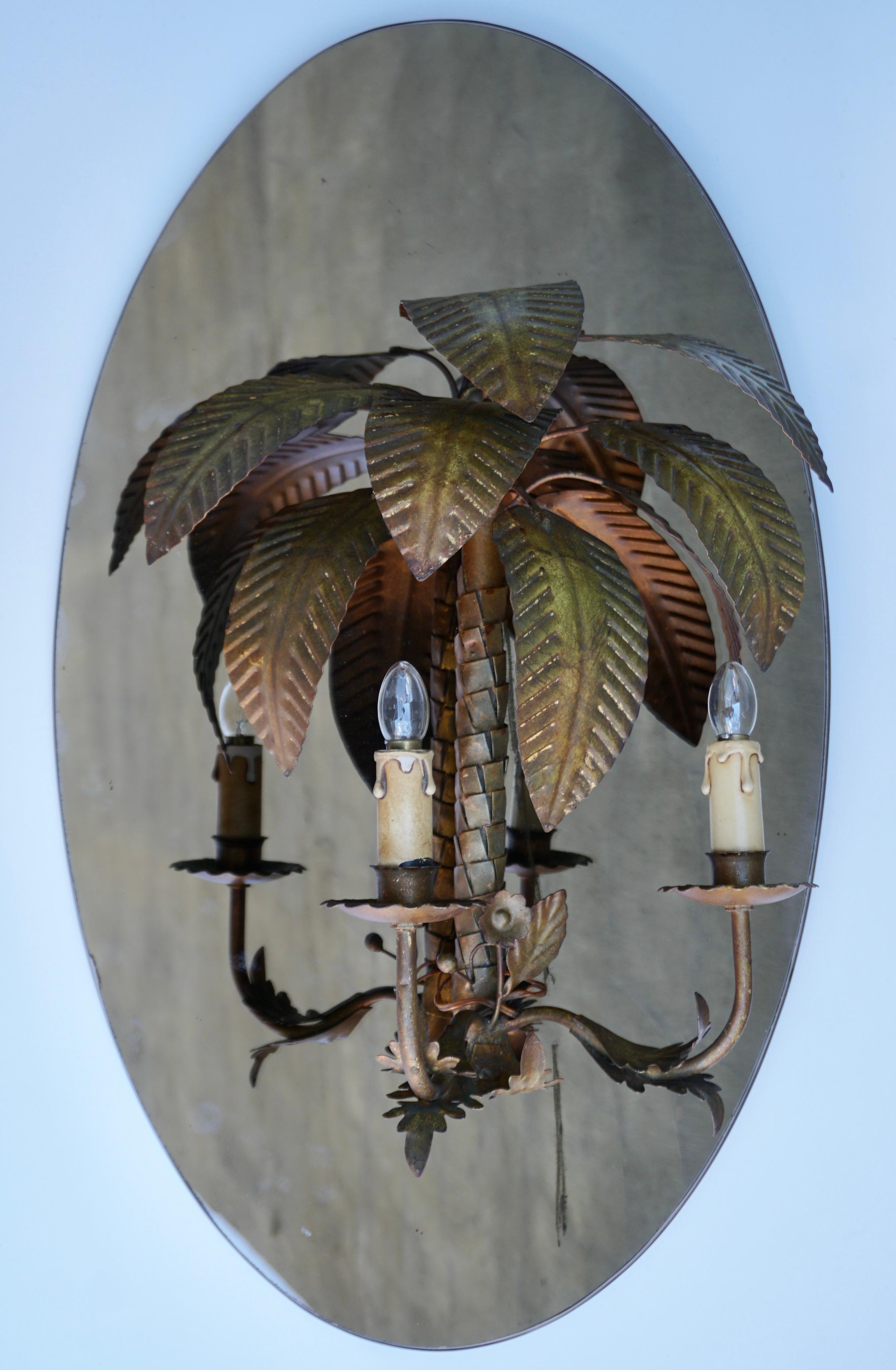 Lovely eye catching vintage Italian palm tree  wall light mirror, circa 1970s.  
Superb Hollywood Regency design that will leave a lasting impression in any room.  The combination of the brass with bamboo looks amazing and provides the wall sconces