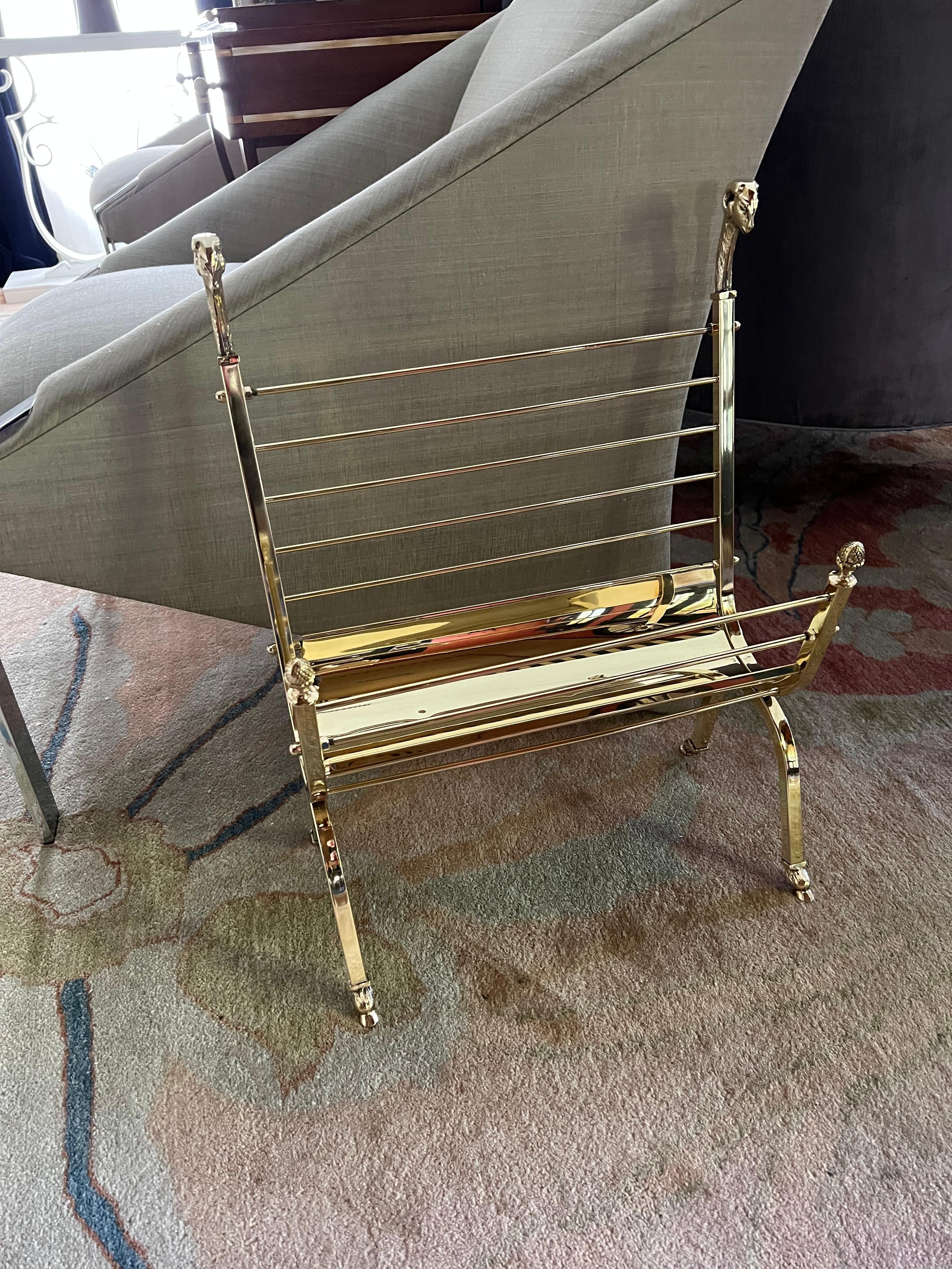 A wonderful brass magazine rack attributed to  Maison Jansen. The rams heads and feet, in true Maison Jansen style set this piece apart. A compliment to any room. The professionally polished brass reveals a truly spectacular shine.