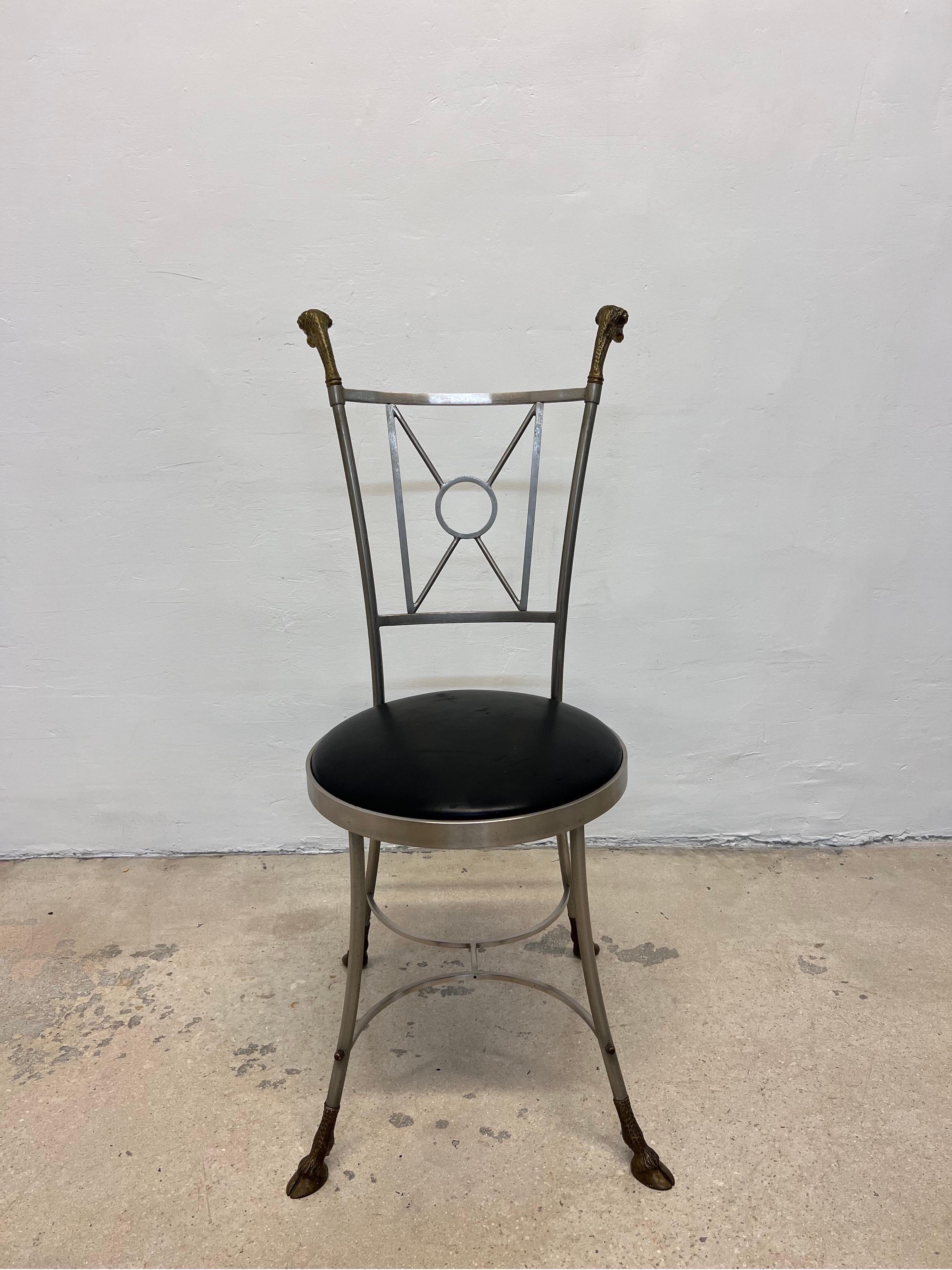 Neoclassical steel side chair with patinated brass rams head and feet accents with a black leather seat in the manner of Maison Jansen. Made in Italy and retains label.