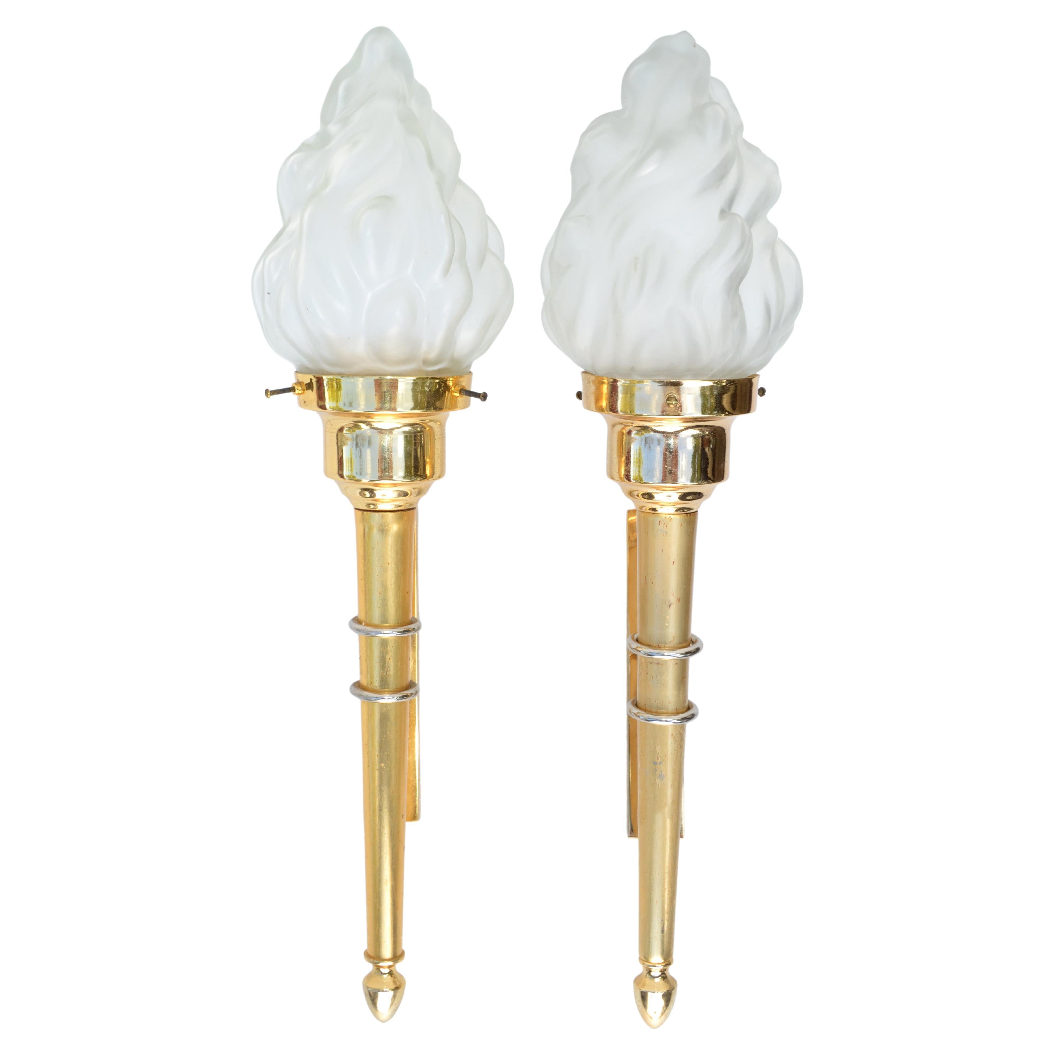 Pair of French Mid-Century Modern sconces, wall lights in brass by Maison Jansen.
Featuring a torch in gold finish with a blown glass flame shade. 
US wired and in working condition, takes one light bulb max. 60 watts.
Priced by pair, we have 2