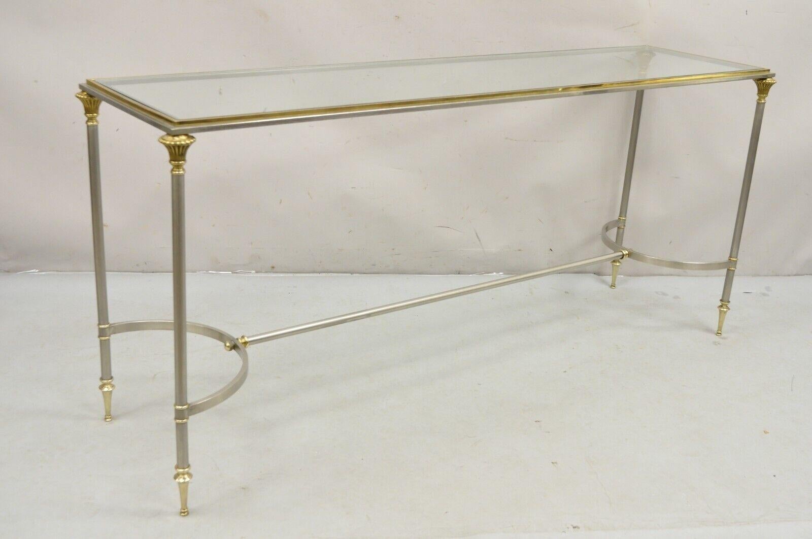 Vintage Italian Maison Jansen Style Steel and Brass Neoclassical Directoire Console Table. Item features Inset glass top, steel and brass frame, clean lines, very nice Italian table. Circa 1970s. Measurements: 27.25