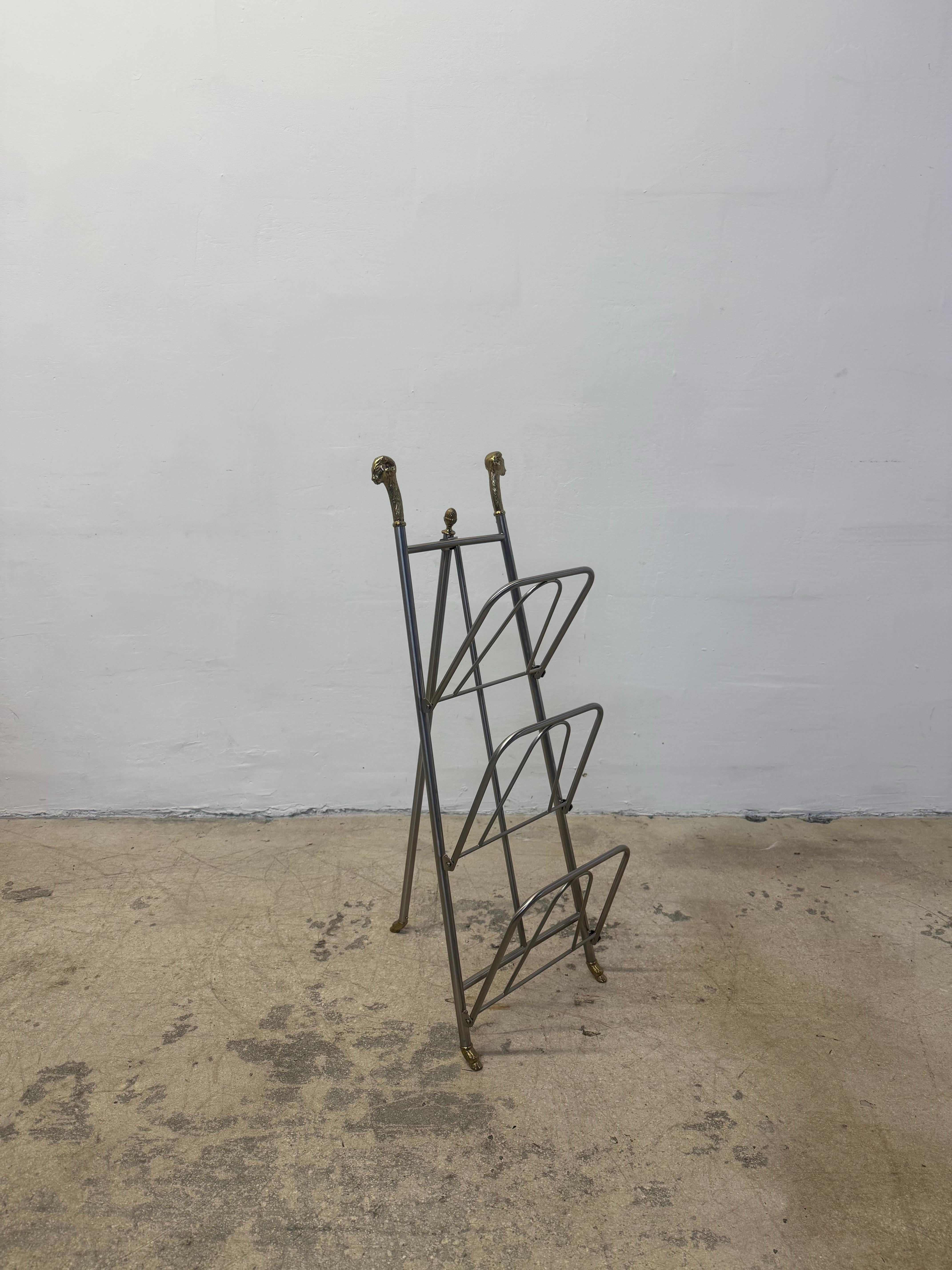 Steel magazine or book rack with brass rams head, feet and acorn in the style of Maison Jansen, Italy 1980s.