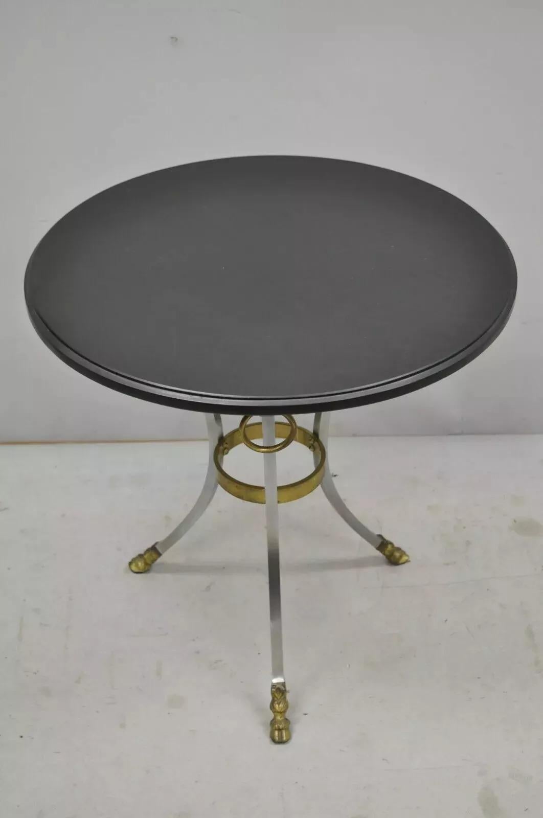 Maison Jansen Style Steel and Bronze Hoof Round Slate Top Regency Side Table. Item features a brushed steel frame, brass/bronze ormolu, hoof feet, and round black slate top. Circa Late 20th Century. Measurements: 24