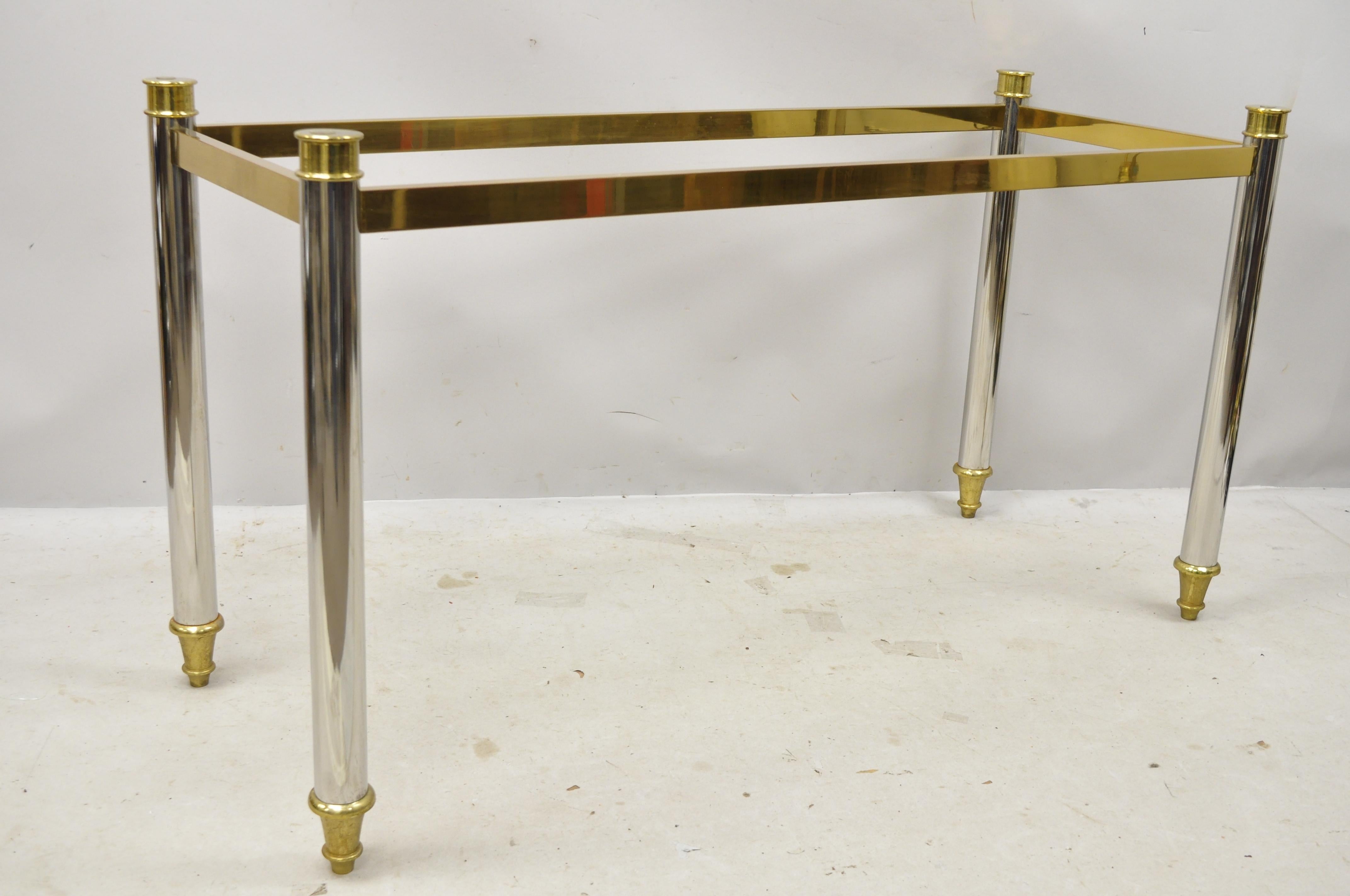 Maison Jansen style steel chrome and brass Hollywood Regency console table base. Item features heavy chrome-plated steel frame, brass accents and feet, remarkable quality, no glass top, overall very nice, circa mid-late 20th century. Measurements: