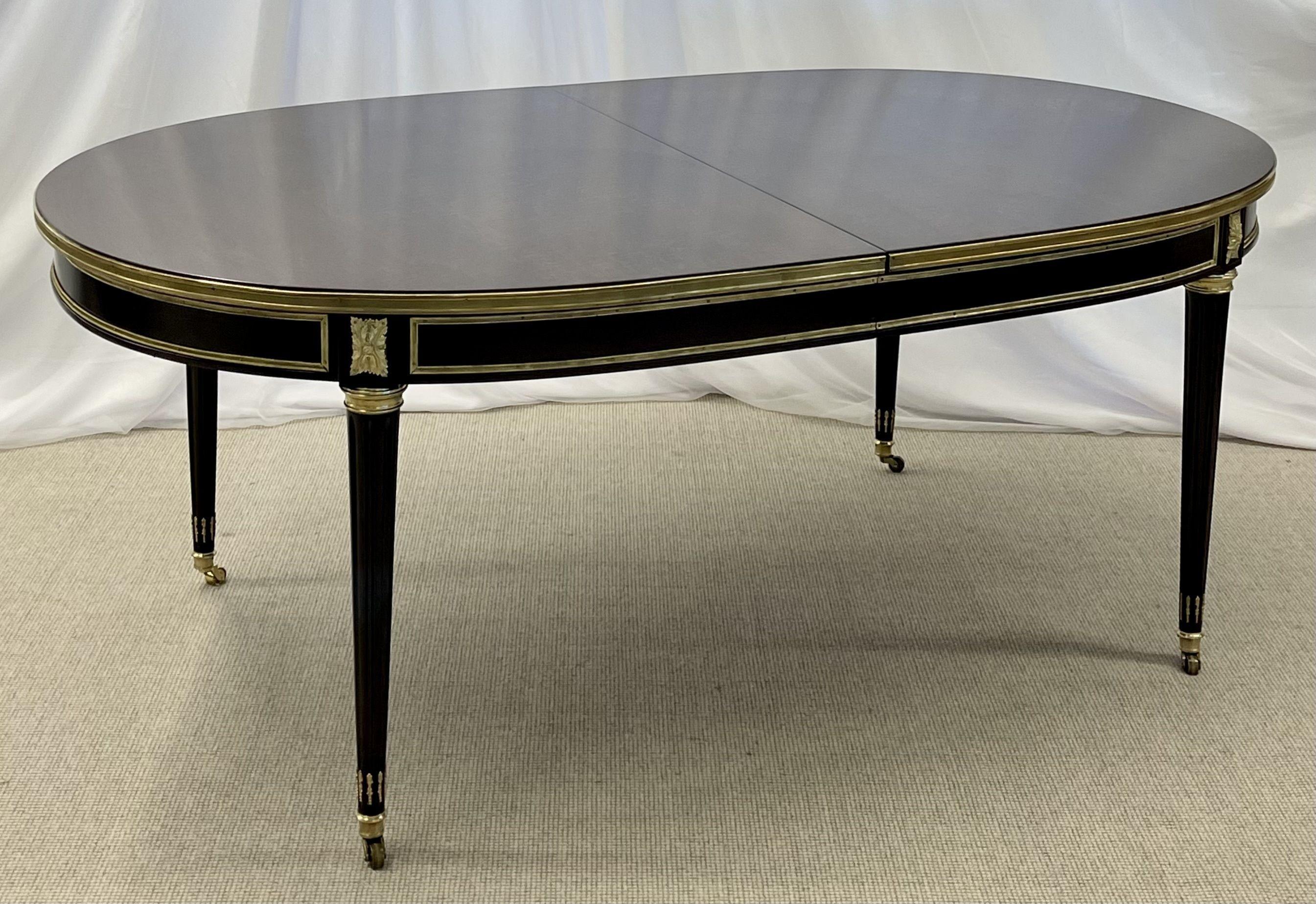 Maison Jansen Tortoise shell finished dining or conference table. This stunning Louis XVI style, bronze mounted, table is simply spectacular. The bronze sabots and casters support a reeded tapering group of table legs supporting a bronze framed