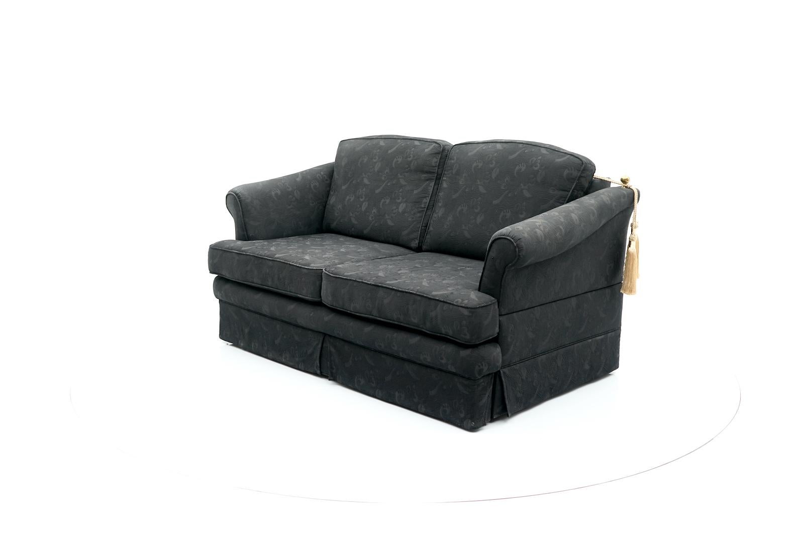 Very comfortable two seater sofa by maison Jansen. The sofa can be pulled out to the guest bed. The handling is very simple. 
The sofa is upholstered in black patterned fabric.

Total width when unfolded 222 cm (87.40 in).
Total length when