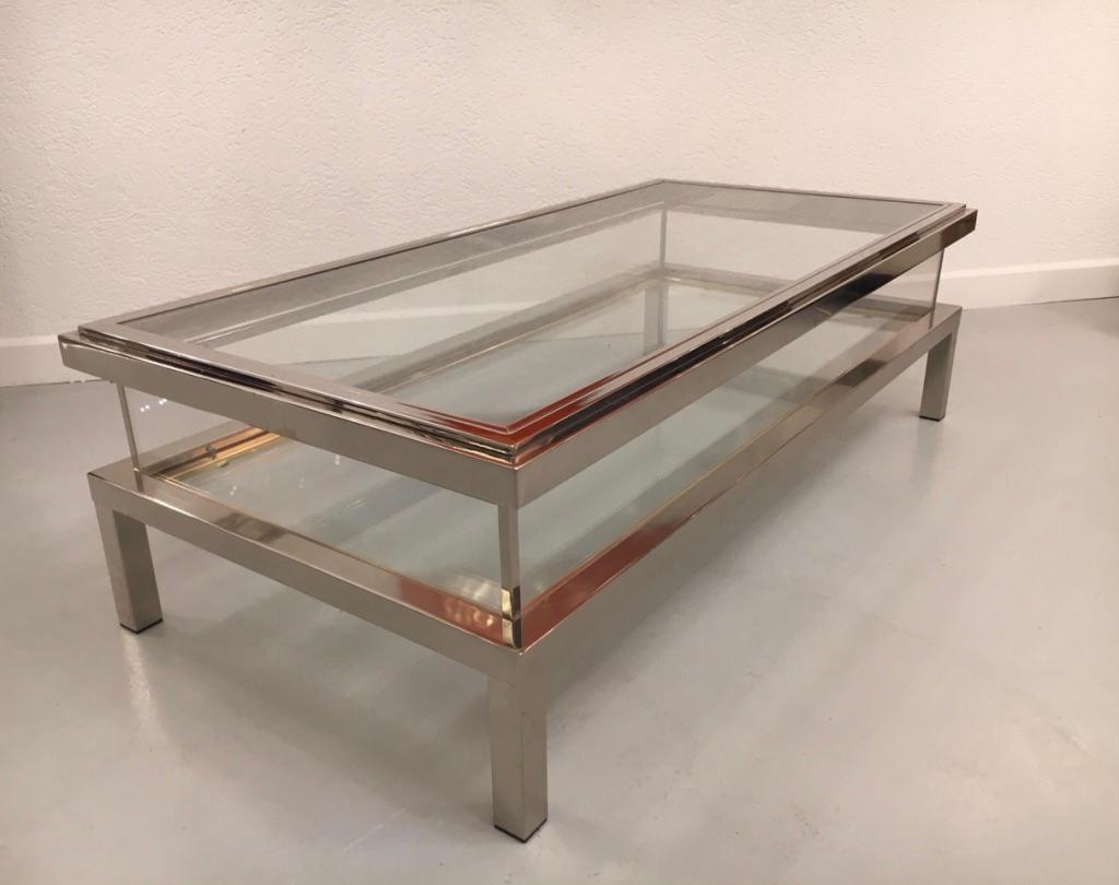 High quality chrome, brass, glass and acrylic vintage sliding top coffee table manufactured by Maison Jansen, France, circa 1970s
Mint condition.
Measures: L 140 x D 68 x H 43 cm
The sliding top allows to use the table as a vitrine and put