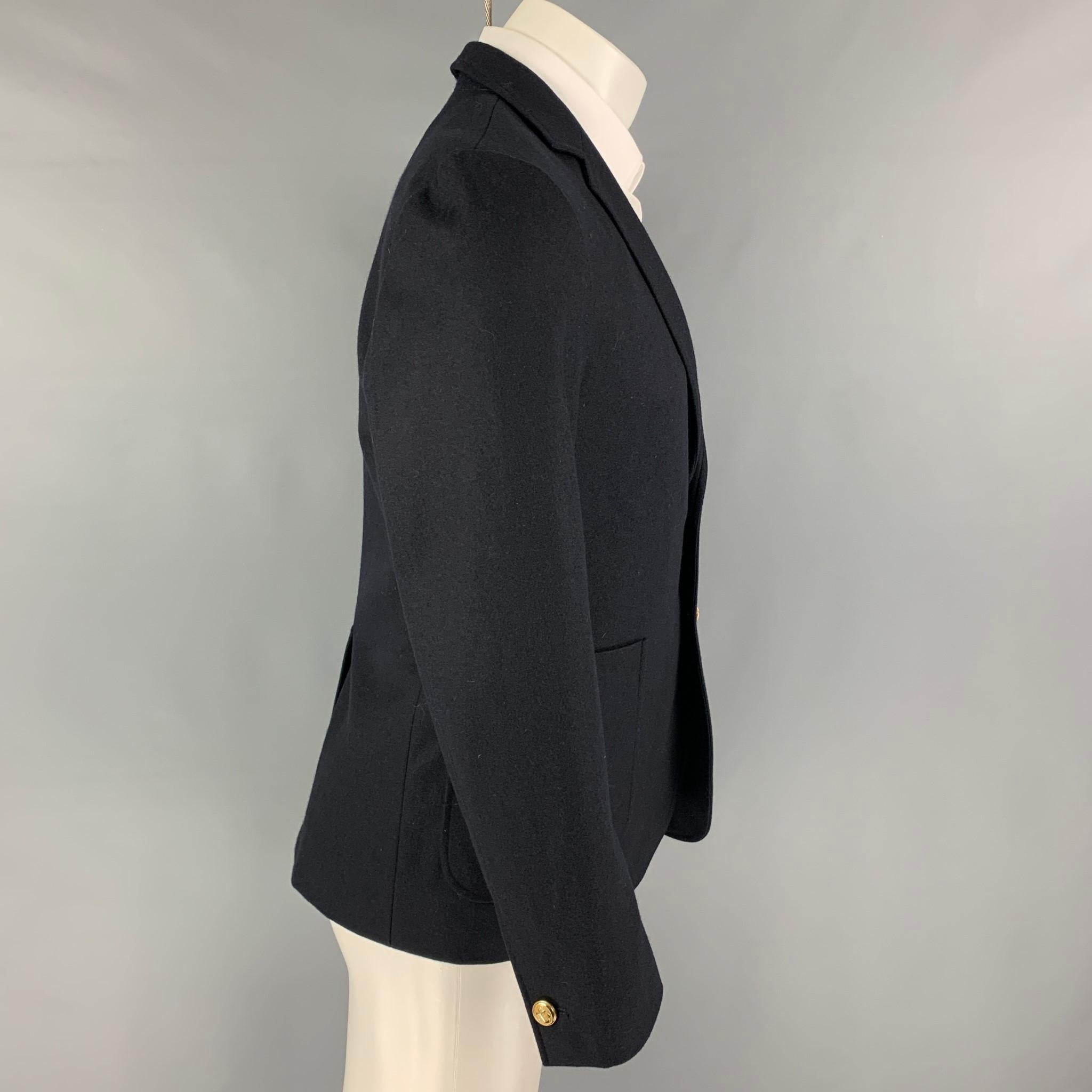 MAISON KITSUNE sport coat comes in a navy wool with a half liner featuring a notch lapel, patch pockets, single back vent, and a double button closure. Made in France.

Excellent Pre-Owned Condition.
Marked: 48

Measurements:

Shoulder: 16.5