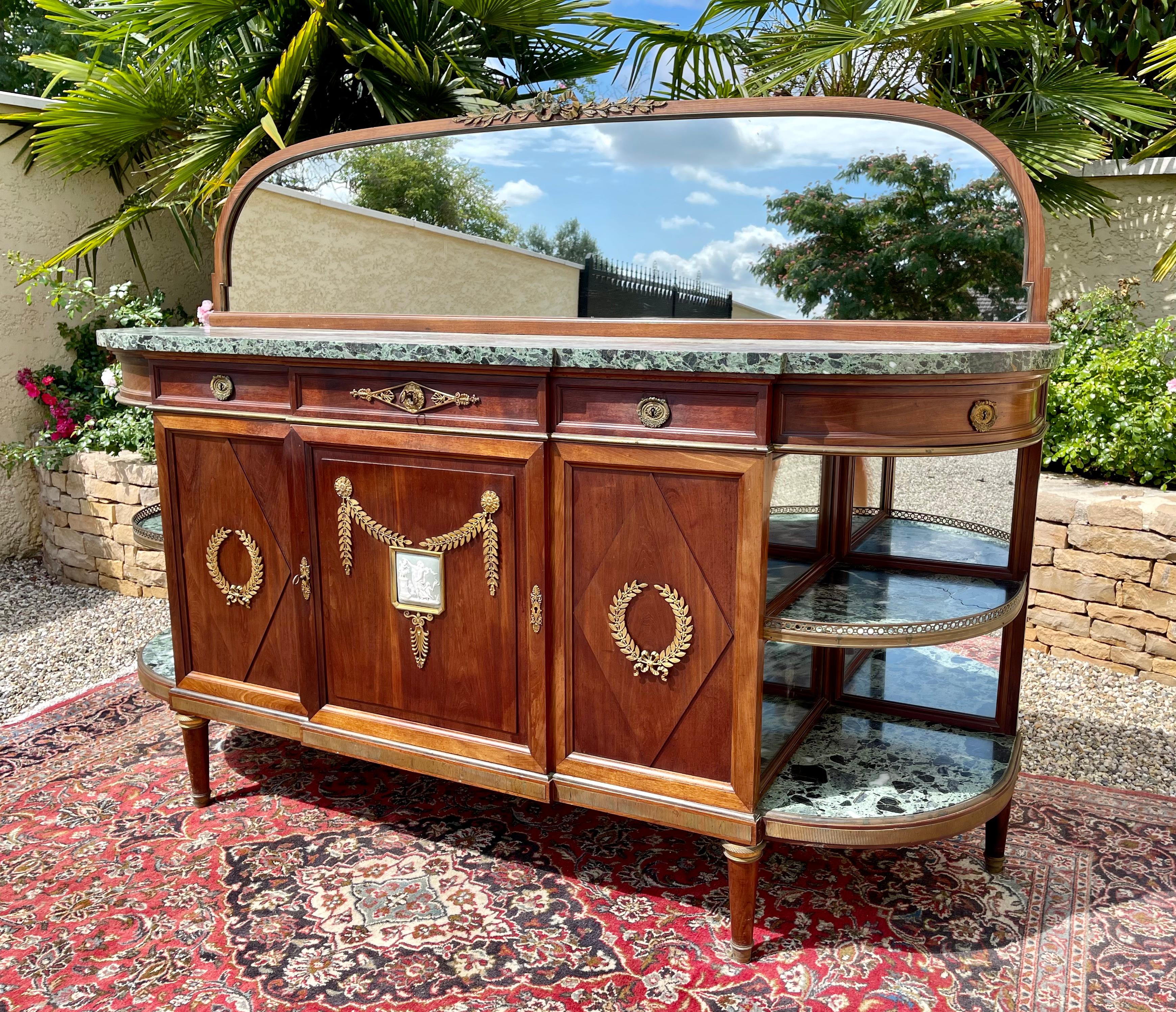 Superb buffet or row of Louis XVI / Napoleon III style dating from the 19th century. It is composed of 5 drawers, 3 on the front and two rounded on each side. In the lower part, there are 2 doors with a shelf inside and finally 2 niches on either