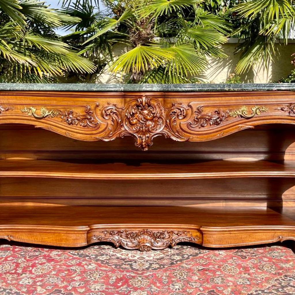 Superb Louis XV style console in richly carved walnut. It has two drawers and a large shelf below. Beautiful sea green marble on the top, original and in good condition. This large console is of very good quality, signed by the famous Maison Krieger