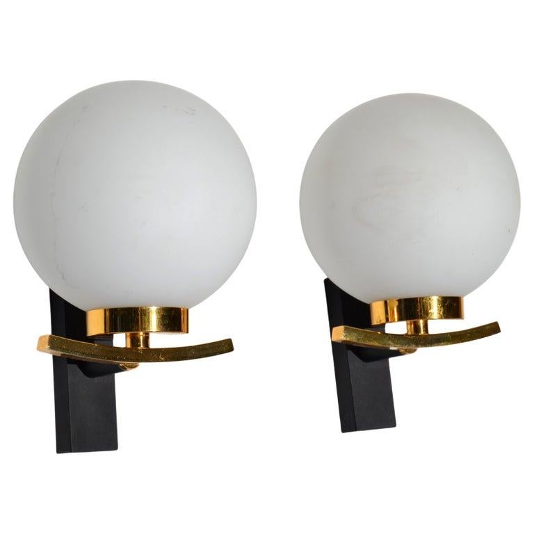 Nice pair of sconces by Maison Lancel in polished Brass, Steel and comes with a round blown Opaline Glass shade. 
US rewiring and each sconce takes one candelabra light bulb with max. 40 watts.
We have 2 Pair available, priced by Pair.
Back Plate