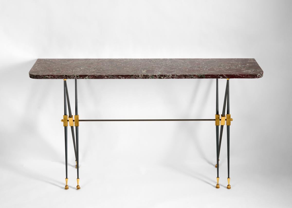 An elegantly pared down console with delicate crossing legs in gunmetal bronze, which, in supporting its marble top gives the piece the appearance of weightlessness.

Bibliography:
The House of Leleu: Classic French Style for a Modern World,