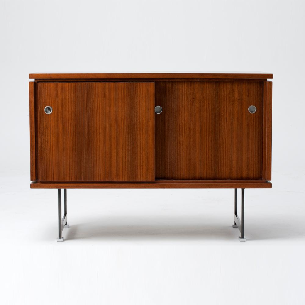 Walnut cabinet with sliding doors, removable shelves and metal legs by Maison Leleu.

For an illustration of a similar model, see Siriex, Franc¸oise. The House of Leleu. New York, Hudson Hills Press, 2008. P. 334