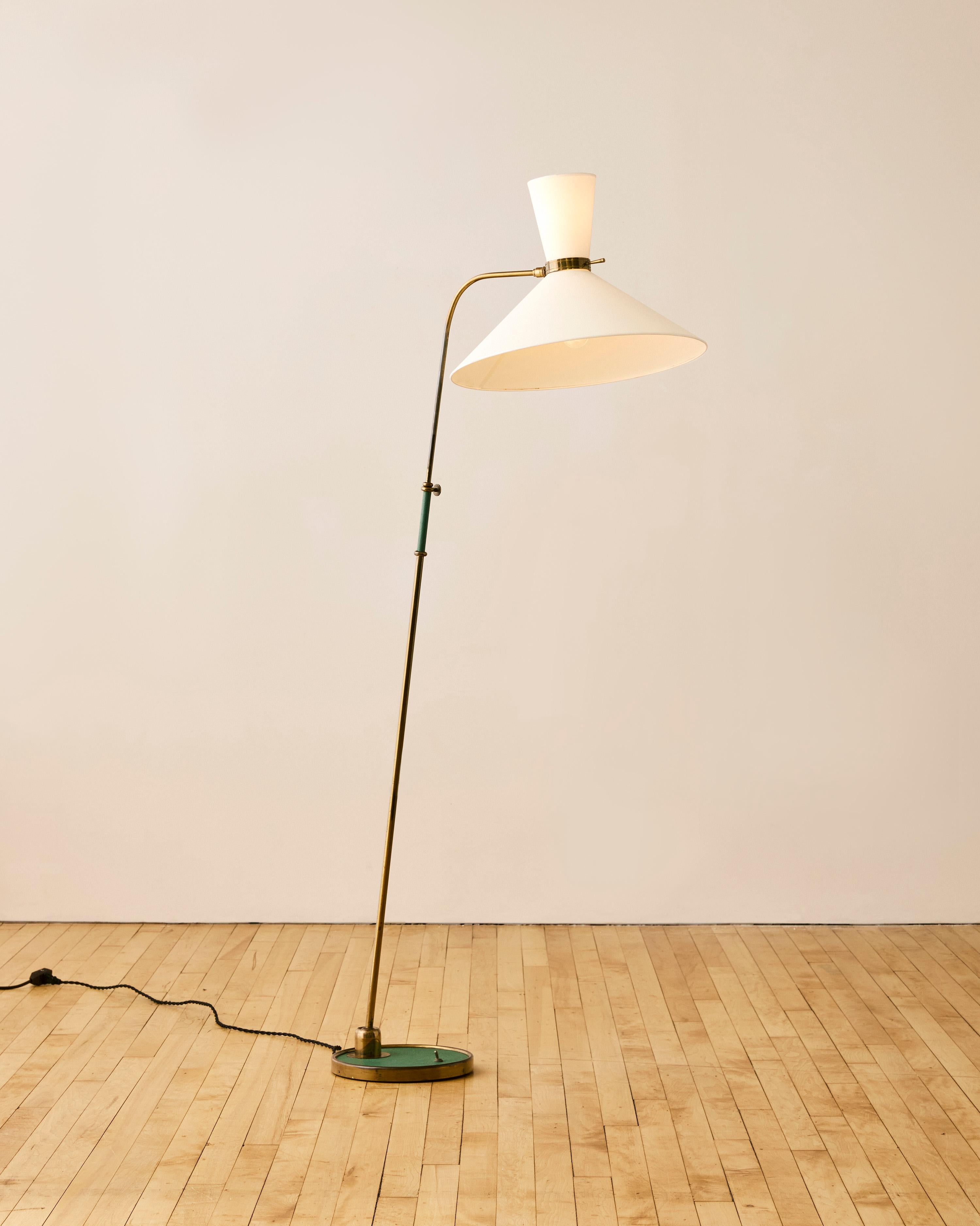 Floor lamp with dual conical shades by Maison Lunel. Featuring green leather accents and brass joinery. Ball in socket adjustable base and head.