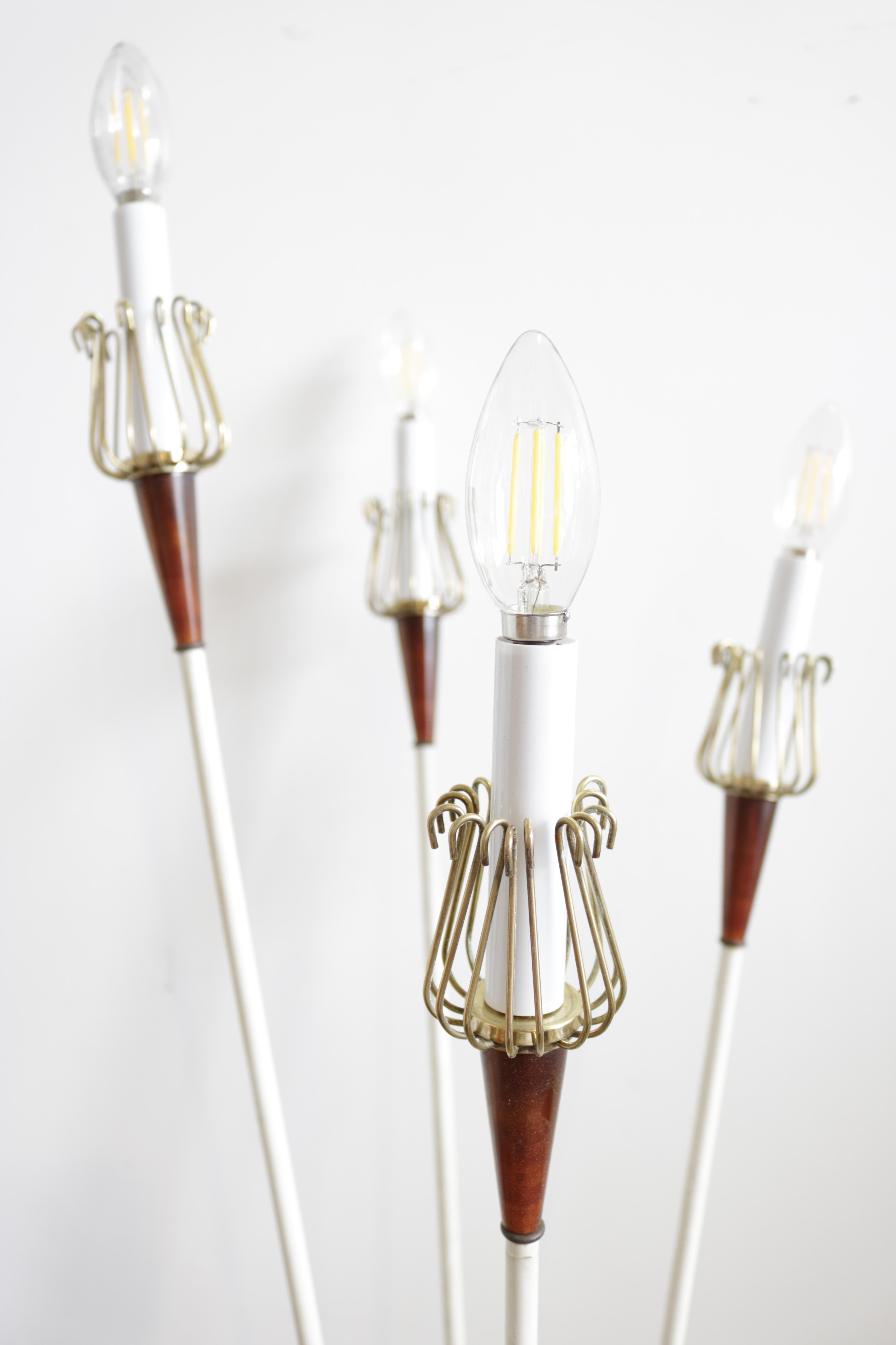Charming 1950s floor lamp designed by Maison Lunel, Paris, France.
Each lamp is comprised of four lamp holders in brass cages supported by cone-shaped red plexiglass supports. The white circular metal bases are finished with brass edging.
Base