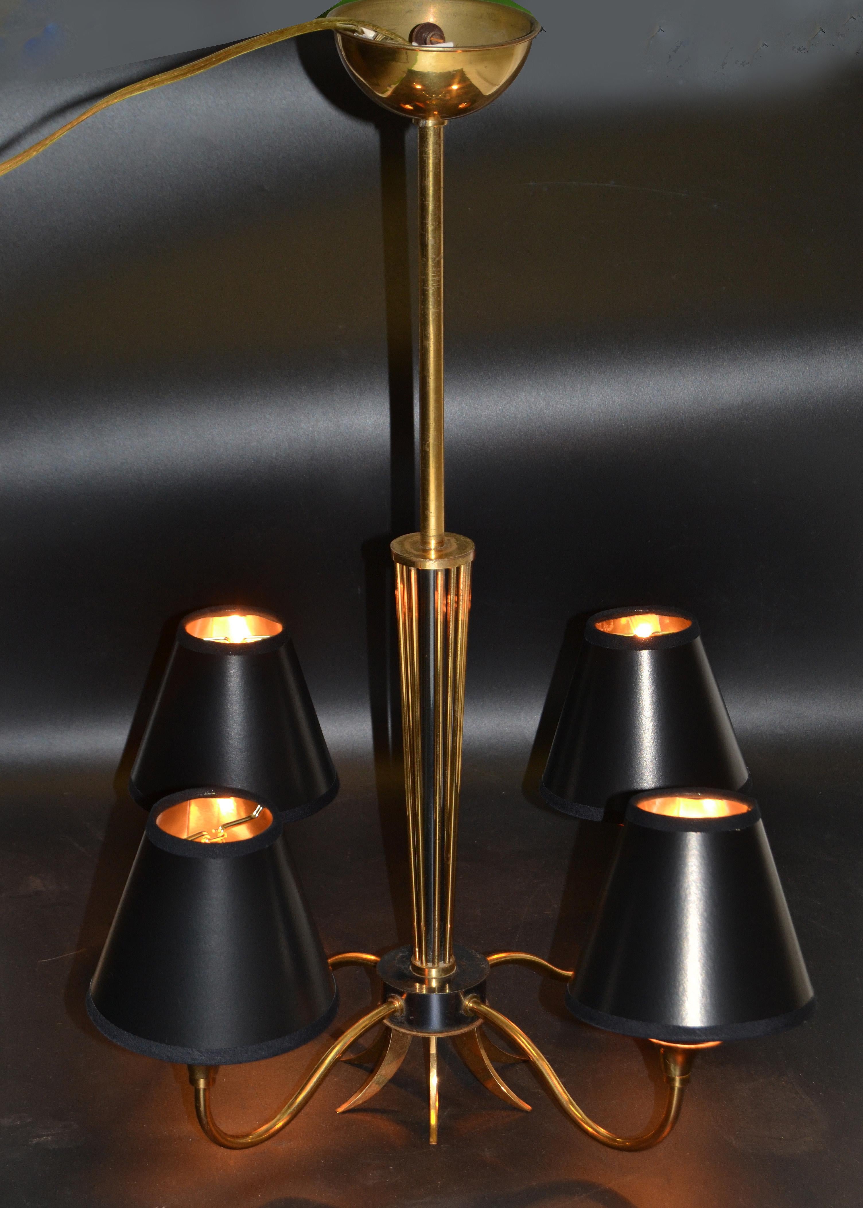 Superb two patina brass and gun metal Maison Lunel four arms chandelier.
US rewired and in working condition each arm takes a max 25 watts light bulb.
Comes with black & gold paper shades.
