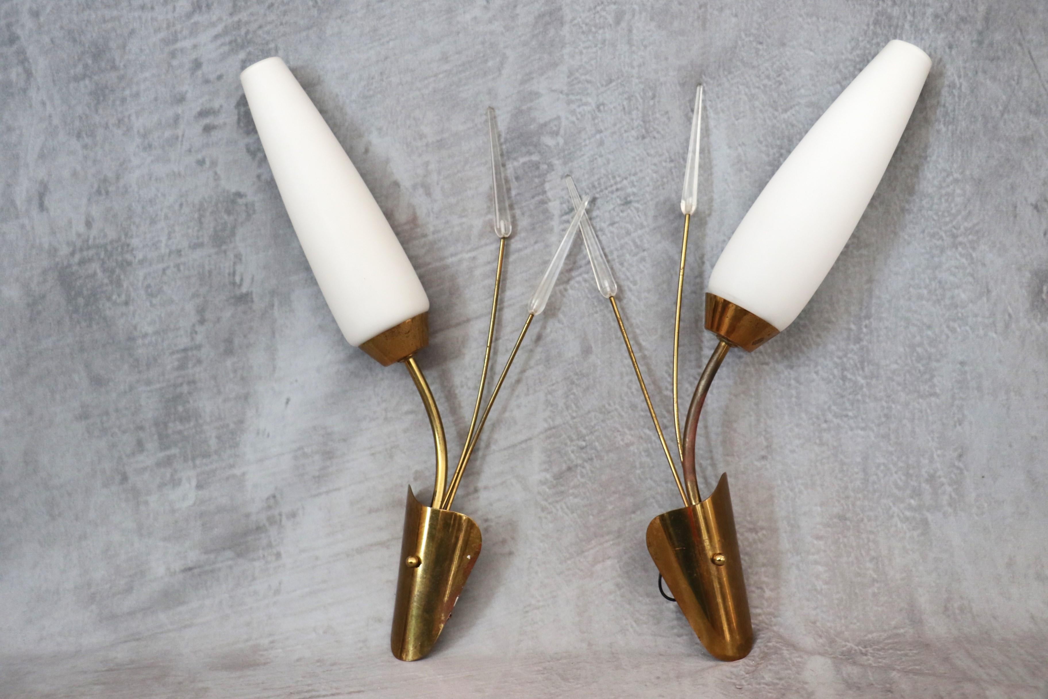 Maison Lunel - Pair of Mid-Century Modern Brass Wall lights - 1950s France

Very nice pair of sconces in the 50's design. 
They are all in contrast: the luminous, milky whiteness of opaline contrasts with the golden base of shiny brass, all