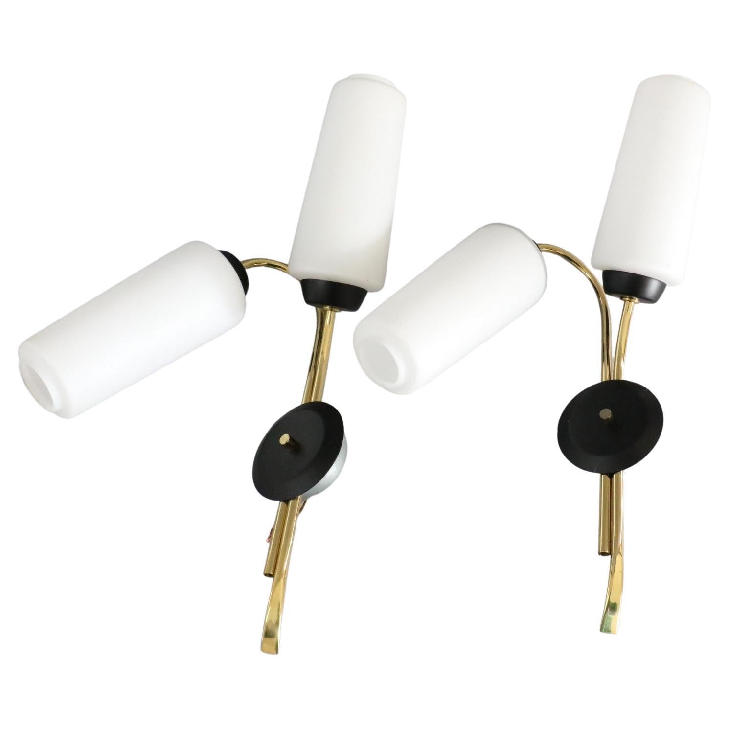 Maison Lunel, Pair of Mid-Century Modern Wall lights, 1950s France

Very nice pair of sconces with a 1950s design. 
They are very contrasted: the luminous and milky white of the opaline is opposed to the dark base of the blackened brass, the