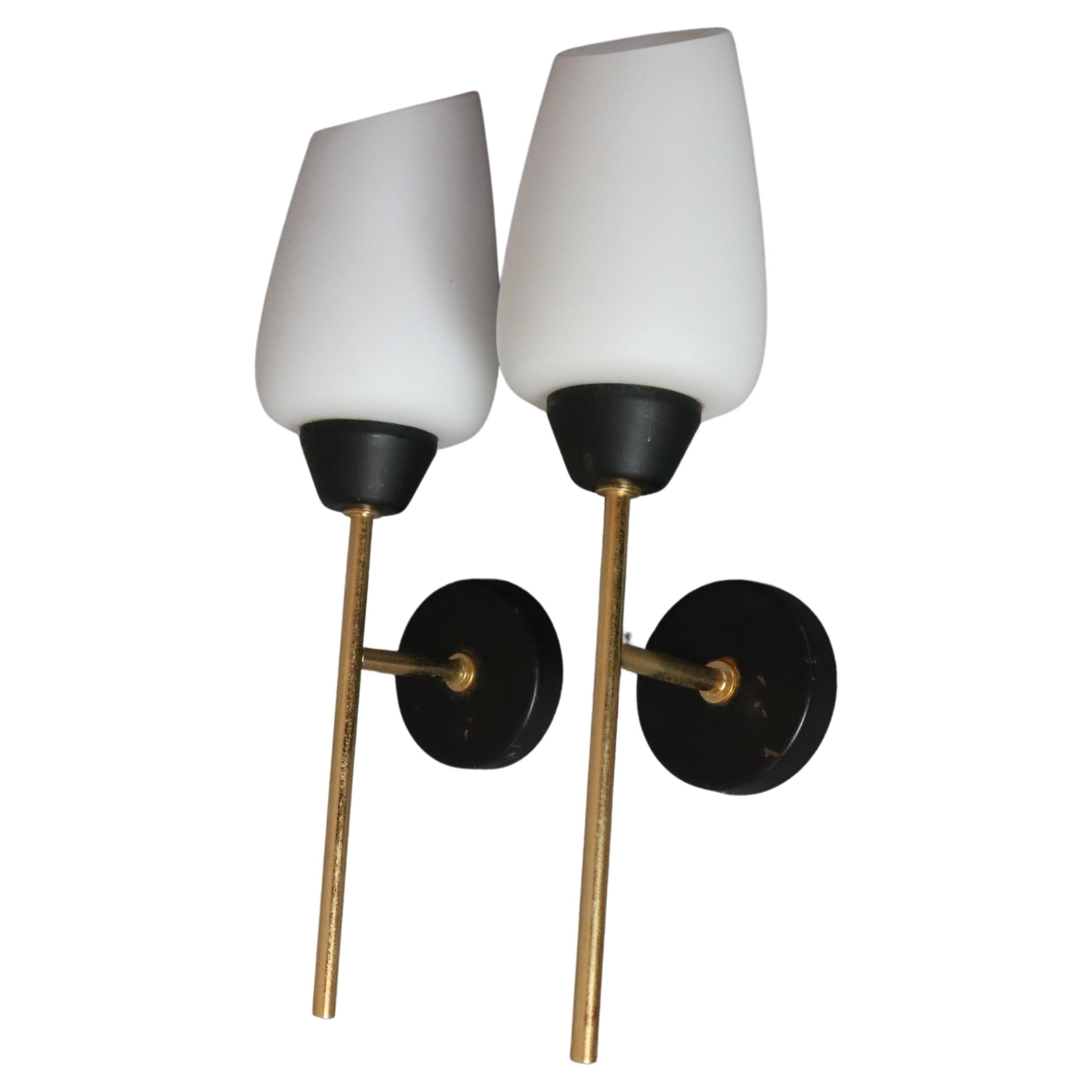 Maison Lunel - Pair of Mid-Century Modern Wall lights - 1950s France

Very nice pair of sconces in the 50's design. 
They are all in contrast: the luminous and milky whiteness of the opaline is opposed to the dark base of the blackened brass, the