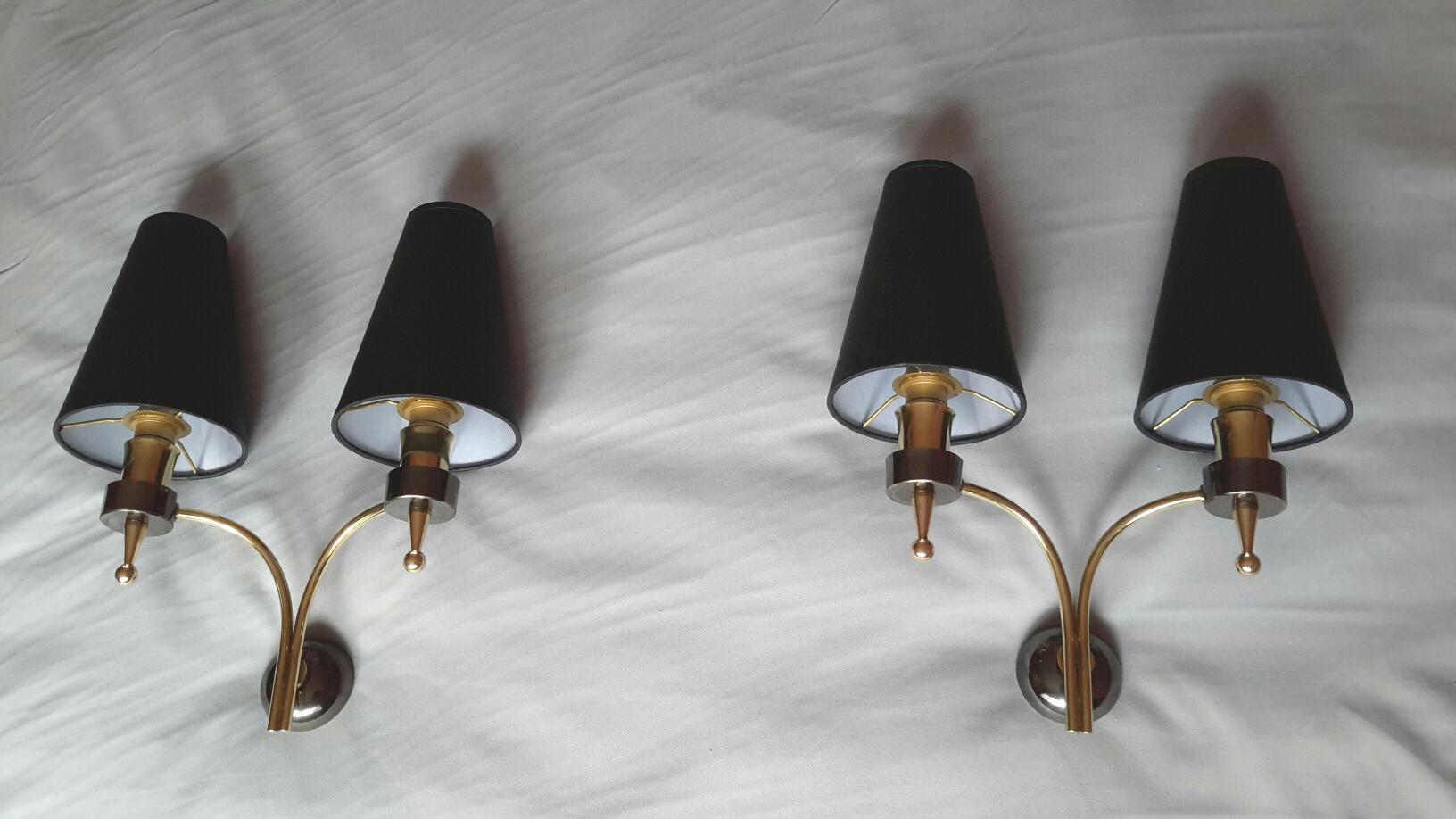 Very elegant pair of French neoclassical double arm sconces of the 1950s in brass and metal gun patina by Maison Lunel. In a very good general condition.
The electric parts have been renewed and fit the US standards. Including all the new black