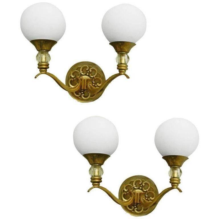 A gorgeous pair of sconces by Maison Lunel, bronze, brass and round Opaline glass. 
US rewired and in working condition. 65 watt max bulb. Back-plate: 3 inches Diameter. I have custom 5 inches Junction Box Covers available. Please ask for a quote.