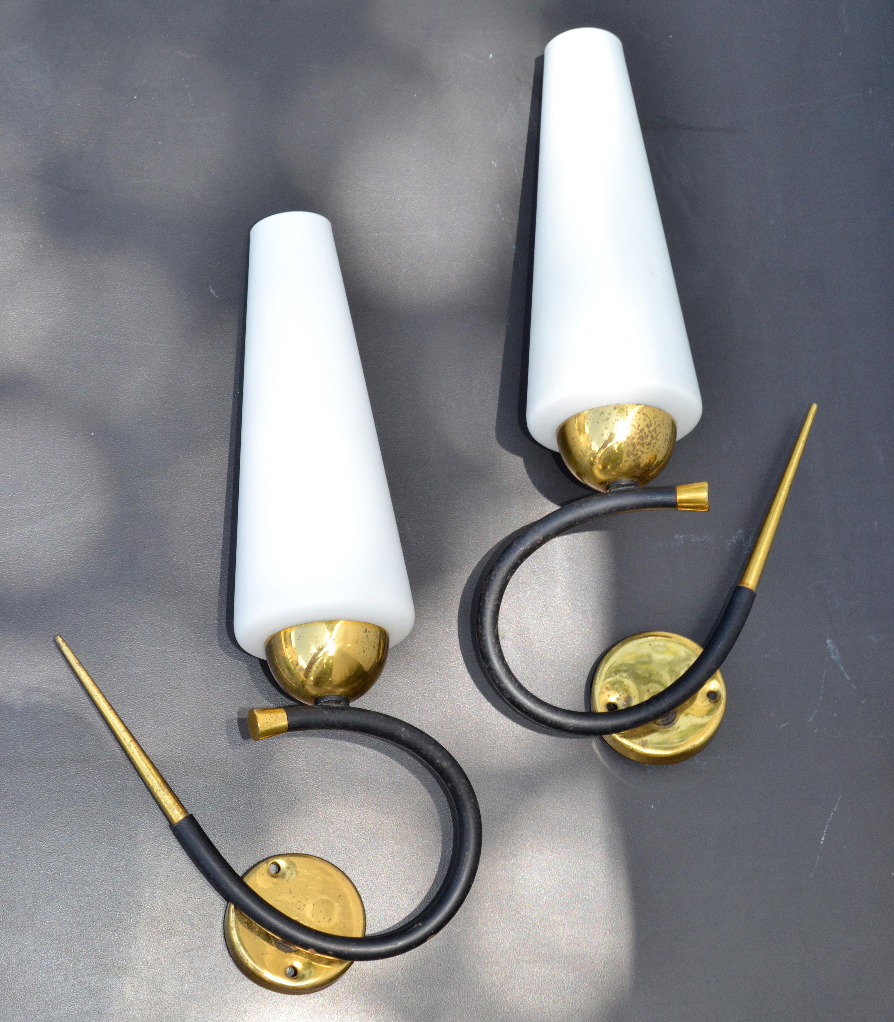 Pair of Maison Lunel sconce, wall light with original cone Opaline shades, made out of Black finish wrought iron and brass details.
Both are the same size and mirror image of each other, superb French Design from the 1960s.
Each Sconces takes 1