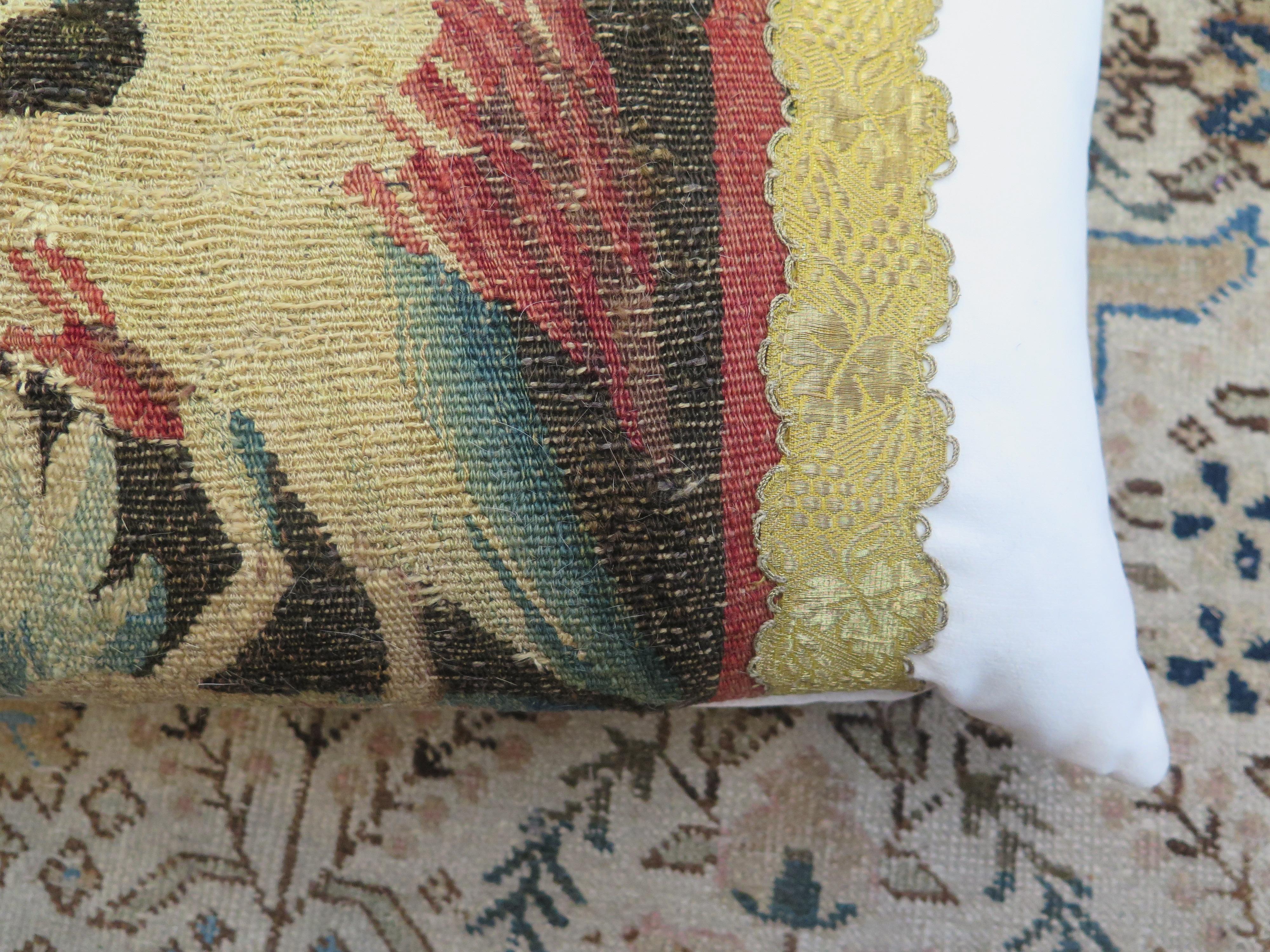 18th century Tapestry pillow featuring a bird with rose red wings. Pillow is constructed of Holly Hunt performance velvet and antique metallic trim. Down filled.