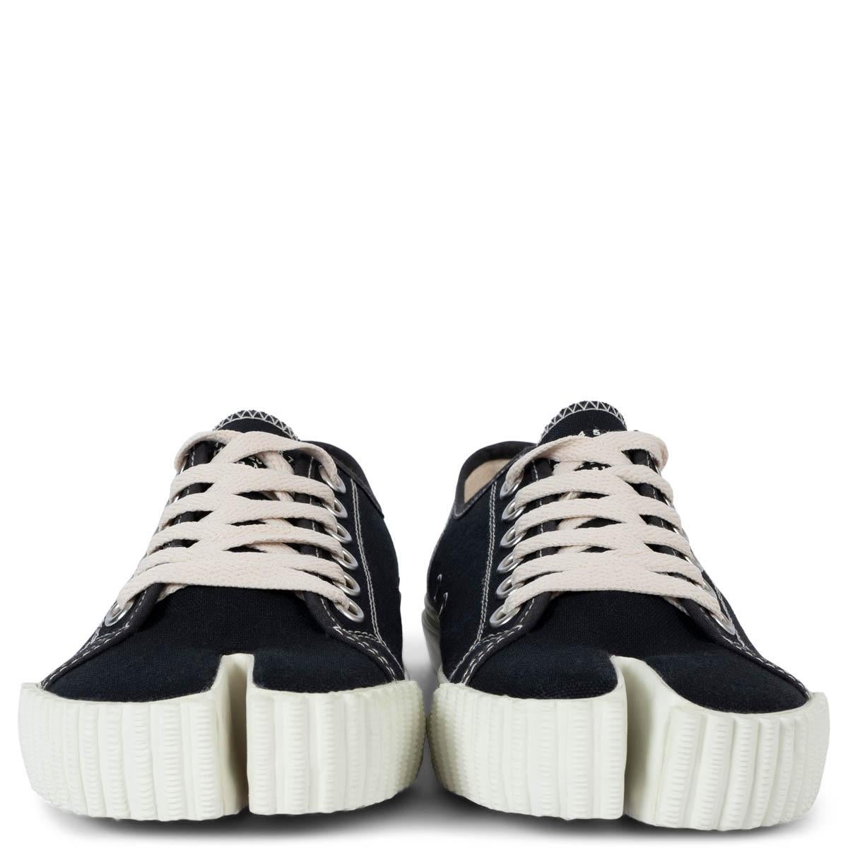 100% authentic Maison Margiela low-top Tabi sneakers in black canvas with white rubber sole. Have been worn once inside and are in virtually new condition. 

Measurements
Imprinted Size	37.5
Shoe Size	37.5
Inside Sole	24.5cm (9.6in)
Width	8.5cm