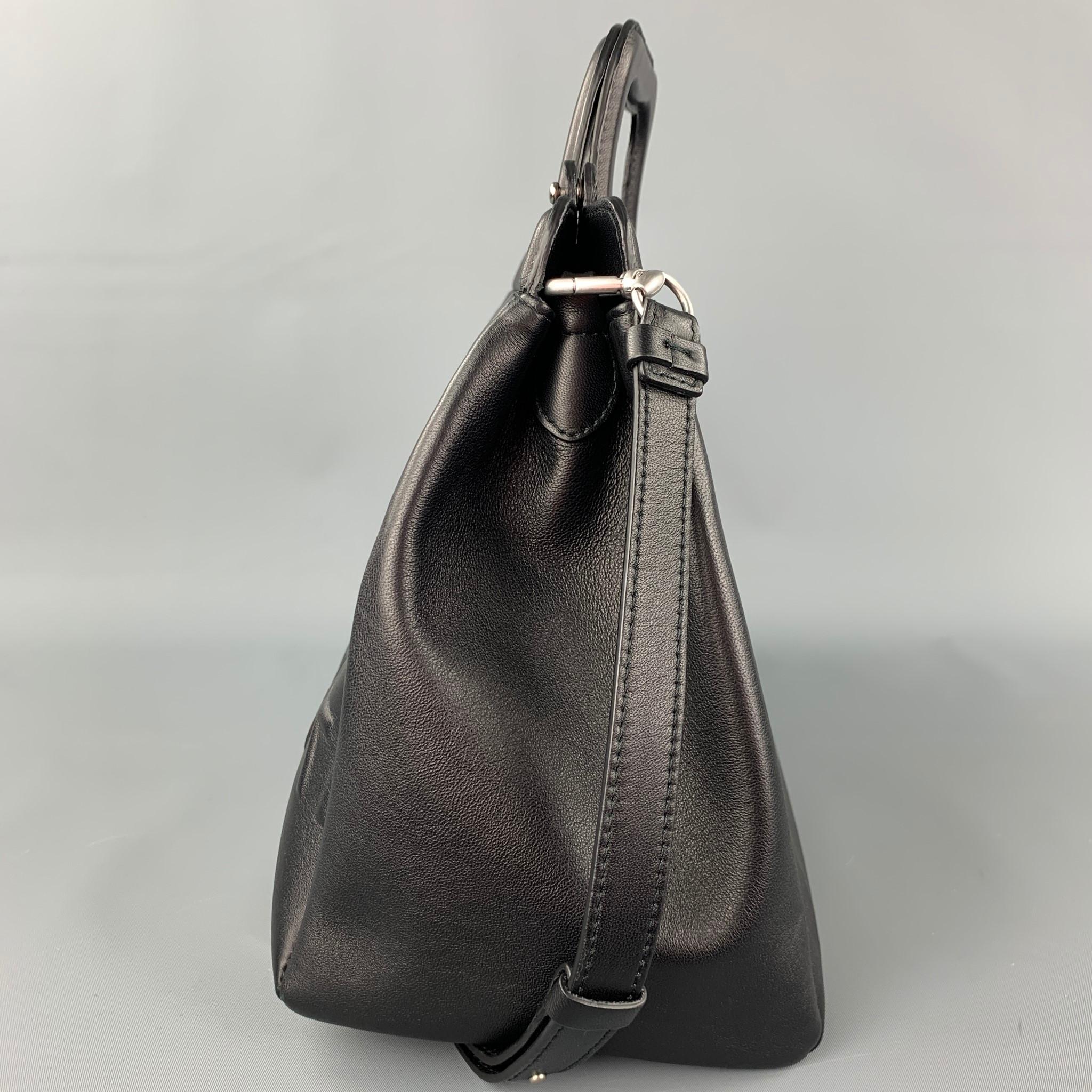 MAISON MARGIELA bag comes in a black leather with a embossed number logo design featuring a shoulder strap, double slots, and a stud button closure.

Excellent Pre-Owned Condition.
Original Retail Price: $1,990.00

Measurements:

Length: 15