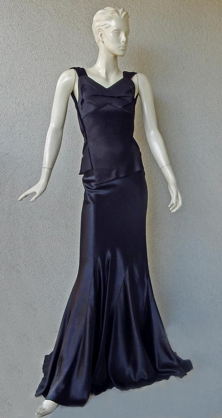 Maison Margiela by John Galliano enchanting bias cut gown.  Features black velvet shoulder straps with narrow asymmetric peplum at waist extending into black silk charmeuse bias godet skirt.  Dramatic exposed back. Sophisticated construction. Side