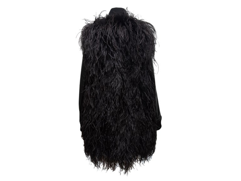 Product Details: Black ostrich feather and leather coat by Maison Margiela. Mock neck collar. Rib knit trim. Zip closure at center front. Designer size 42. 37
