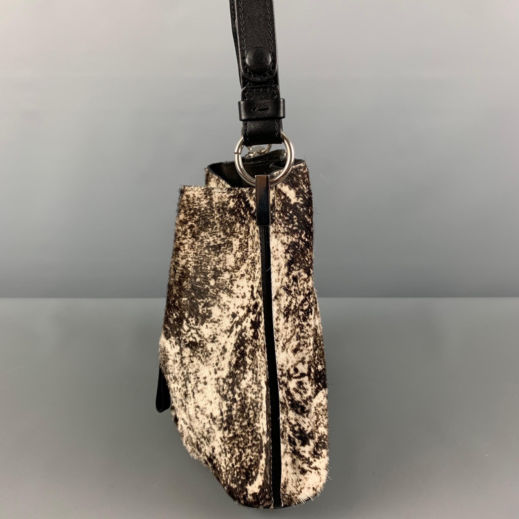 MAISON MARGIELA handbag comes in a brown & cream marbled calfskin featuring a leather top handle strap, dual compartments. Made in Italy.

Excellent Pre-Owned Condition.

Measurements:

Length: 9.25 in.
Width: 4.7 in.
Height: 8 in.
Drop: 12 in.