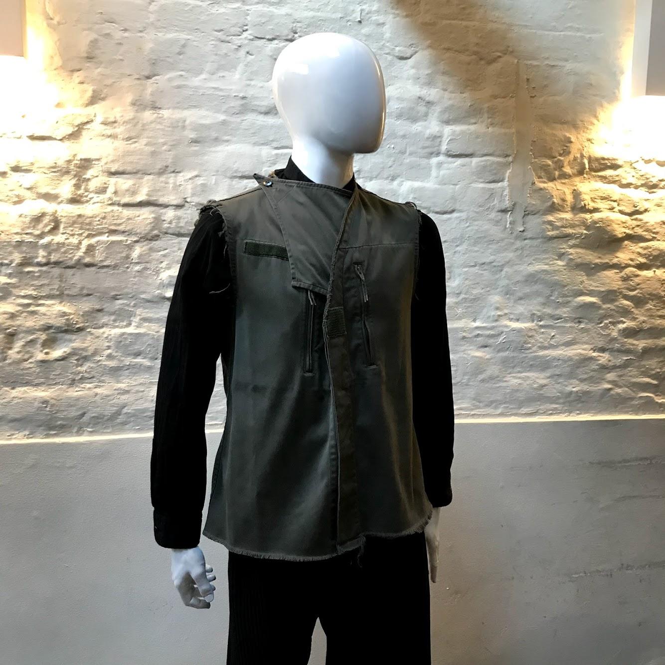 Maison Margiela Combat Style Waistcoat made in France from cotton. 

Maison Margiela is a French fashion House, founded in Paris in 1988 by Belgian designer Martin Margiela. Both masculine and feminine, oftentimes fusing the two genders, the House