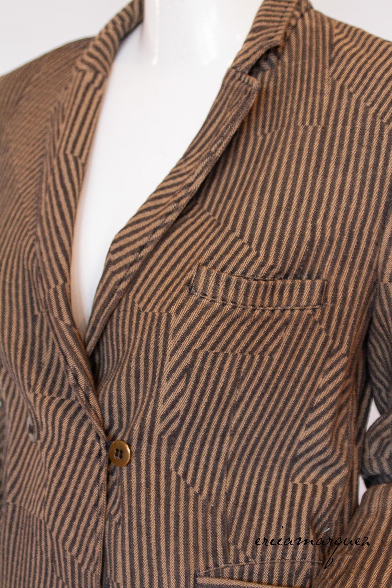This classic Maison Margiela jacket is expertly crafted from 100% cotton and features an eye-catching illusion of black and brown stripes pattern going different ways. Designed with a timeless fitted silhouette with notched collar and a 4-button