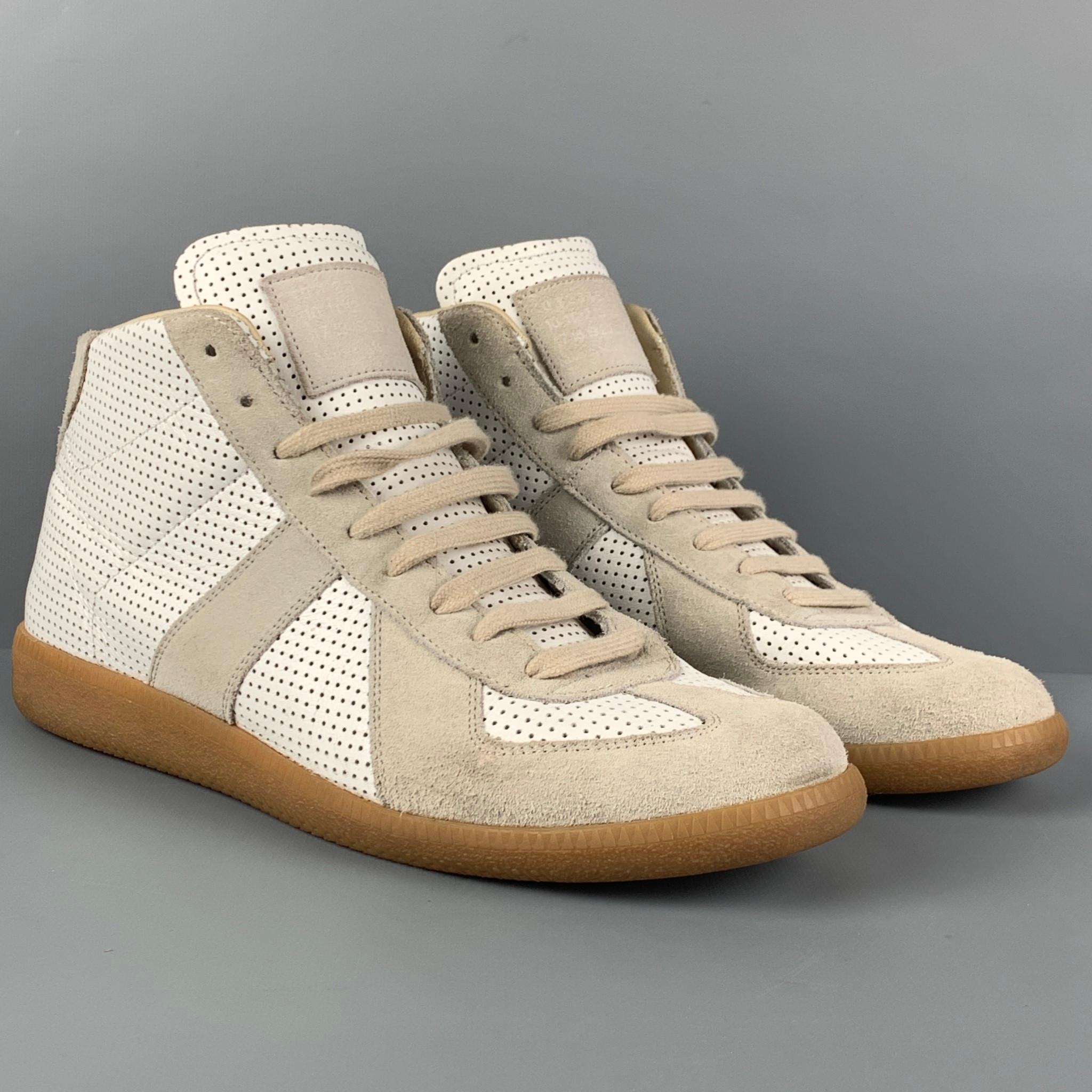 MAISON MARGIELA 'REPLICA' sneakers comes in a white & natural perforated leather featuring a high top style,rubber sole, and a lace up closure. Made in Italy. 

Very Good Pre-Owned Condition.
Marked: 43

Outsole: 11.5 in. x 4 in. 