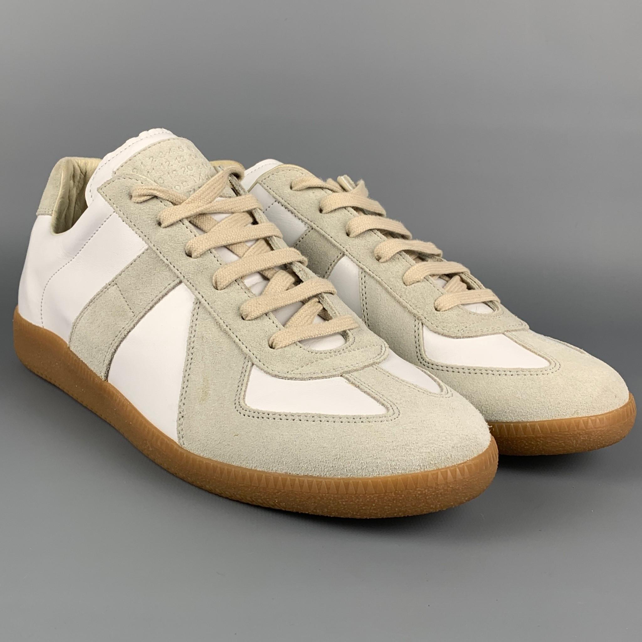 MAISON MARGIELA 'REPLICA' sneakers comes in a white color block leather featuring a suede trim, rubber sole, and a lace up closure. Made in Italy. 

Very Good Pre-Owned Condition.
Marked: 44

Outsole: 12 in. x 4 in. 
