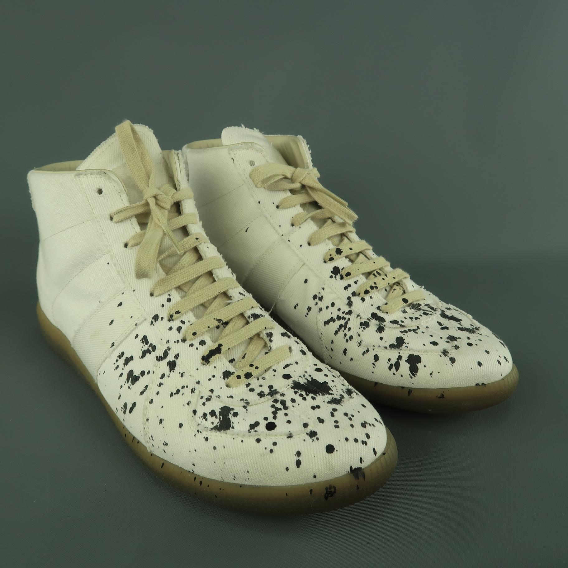 MAISON MARGIELA high top trainers come in off white canvas twill with a beige rubber sole, lace up front, and black ink splatter effect. Minor wear. Made in Italy.
 
Very Good Pre-Owned Condition.
Marked:IT 44
 
Outsole: 12 x 4 in.