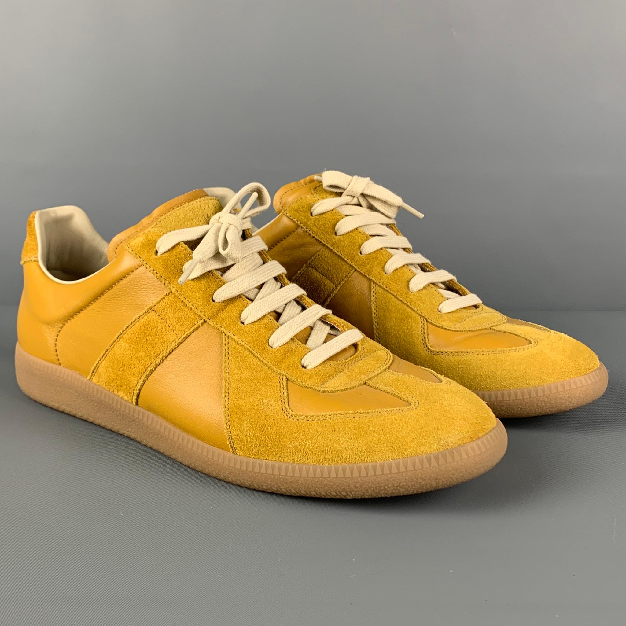 MAISON MARGIELA 'Replica' sneakers comes in a mustard leather featuring a rubber sole and a lace up closure. Includes box. Made in Italy. 

Very Good Pre-Owned Condition.
Marked: 45
Original Retail Price: $540.00

Outsole: 12.25 in. x 4 in. 
