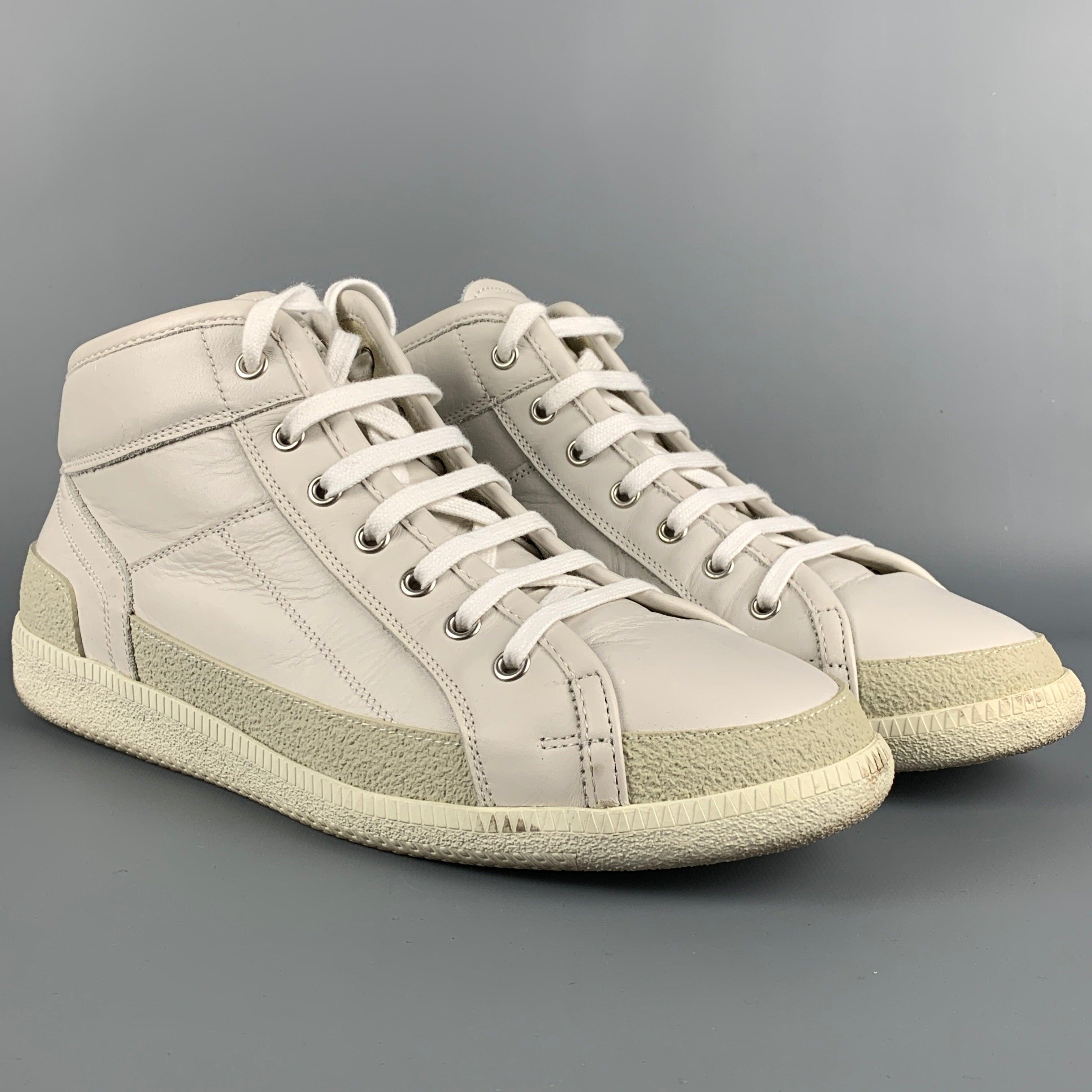 MAISON MARGIELA sneakers comes in a white leather featuring a high top style, rubber sole, and a lace up closure. Includes box. Made in Italy.
 Very Good
 Pre-Owned Condition. 
 

 Marked:  42Outsole: 11.5 inches x 4 inches 
  
  
  
 Sui Generis