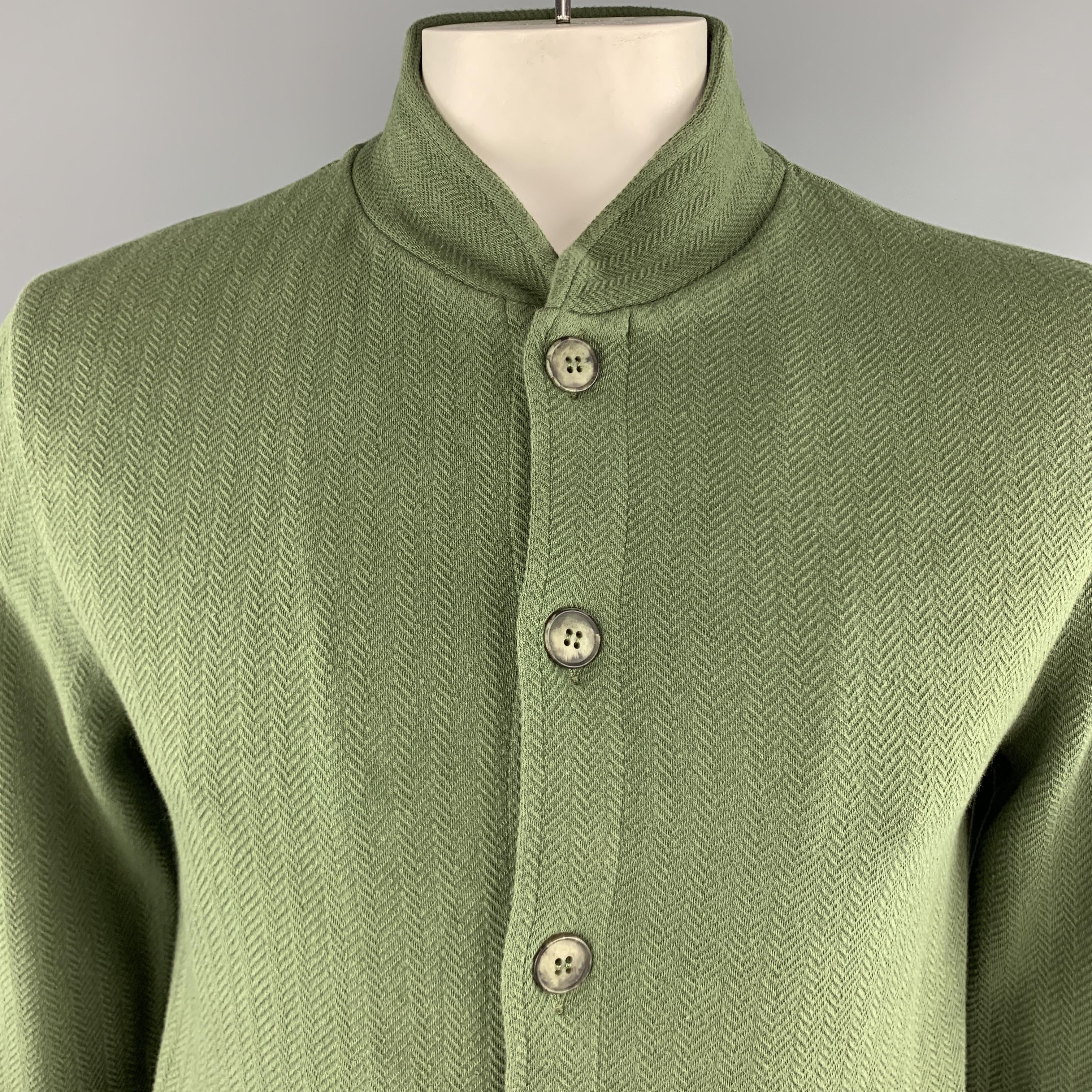 MAISON MARGIELA jacket comes in green herringbone print jersey knit with a nehru collar, button up front, slanted slit pockets, and back stitches. Made in Italy.

Excellent Pre-Owned Condition.
Marked: L

Measurements:

Shoulder: 18 in.
Chest: 42