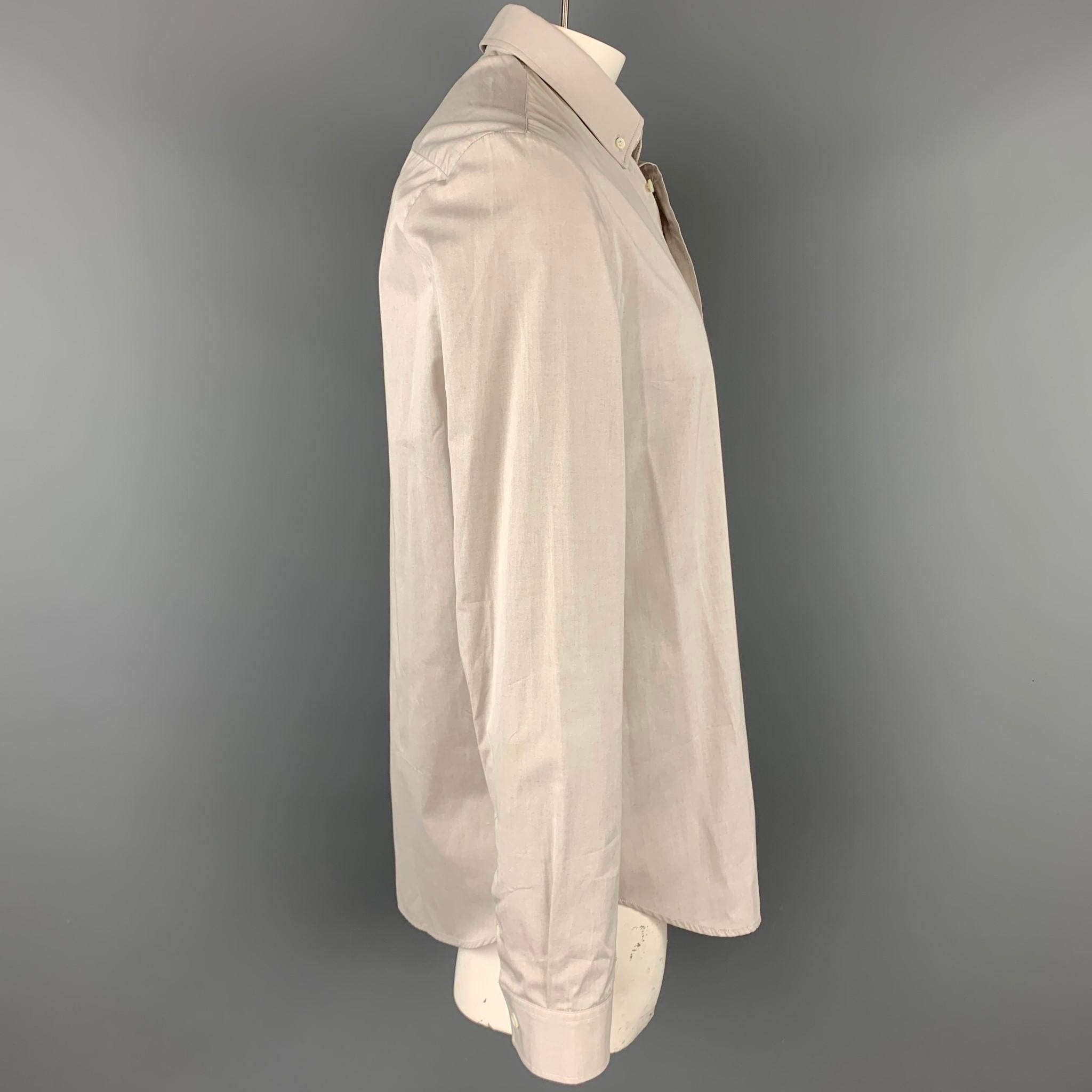 MAISON MARGIELA long sleeve shirt comes in a light grey cotton featuring a classic style and a button down closure. Made in Romania.

Very Good Pre-Owned Condition.
Marked: EU 43

Measurements:

Shoulder: 19.5 in.
Chest: 48 in.
Sleeve: 27.5