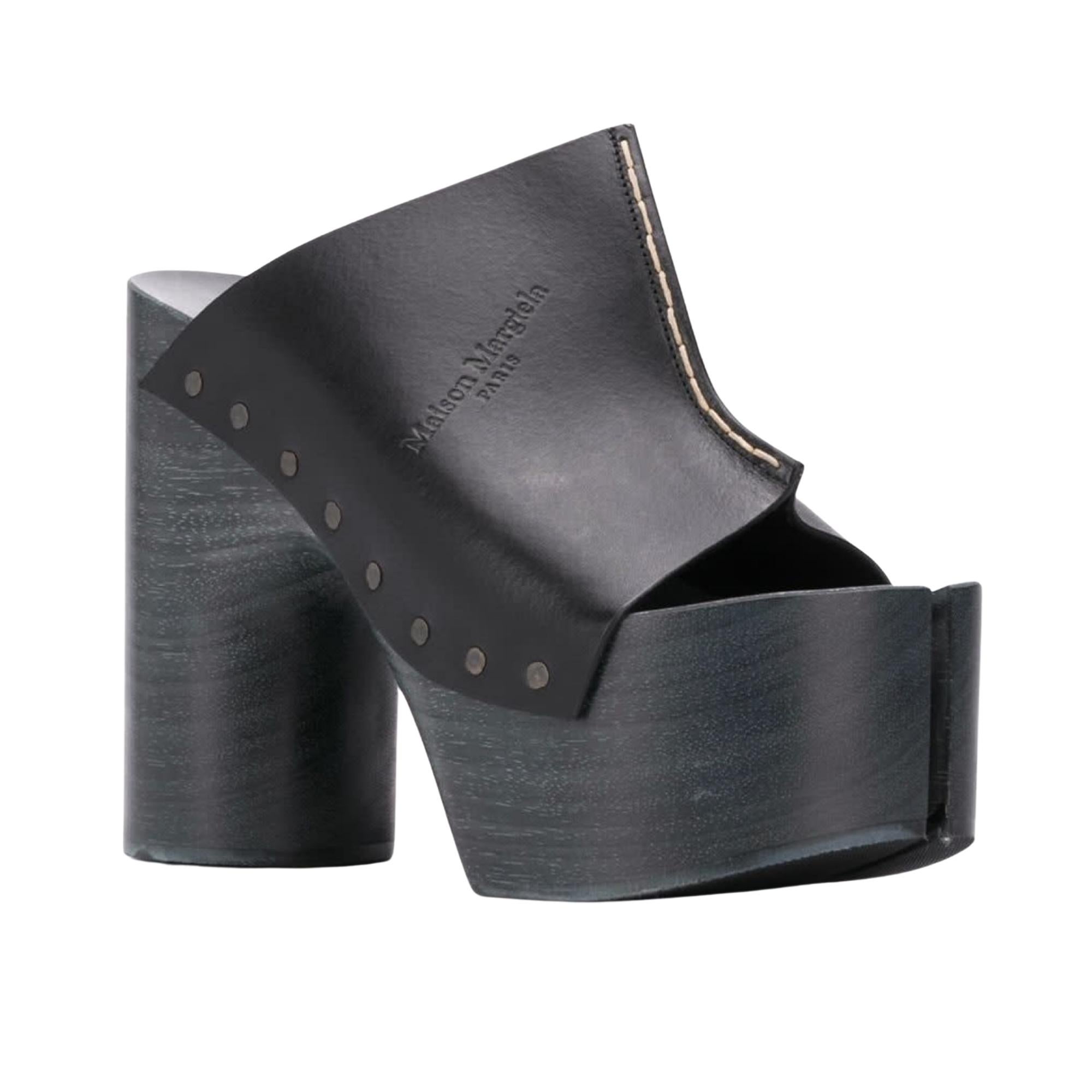 Champions of making the camel toe fashion, Maison Margiela incorporate the Tabi toe into these sky-high clog heels for added drama.
The elevated heels feature leather, contrast stitching, round toe, geometric block wooden heel, wood platform and a