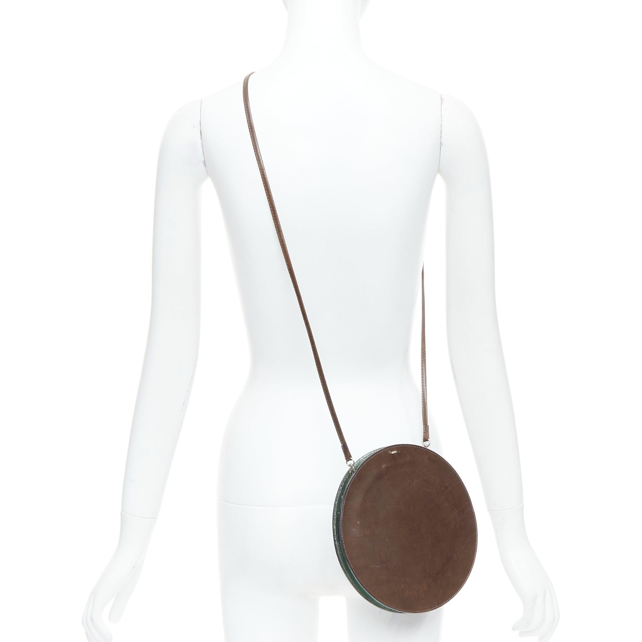 MAISON MARGIELA Vintage brown circular kisslock crossbody bag
Reference: ALCU/A00038
Brand: Maison Margiela
Material: Leather
Color: Brown, Green
Pattern: Solid
Closure: Kiss Lock
Lining: Green Leather

CONDITION:
Condition: Fair, this item was