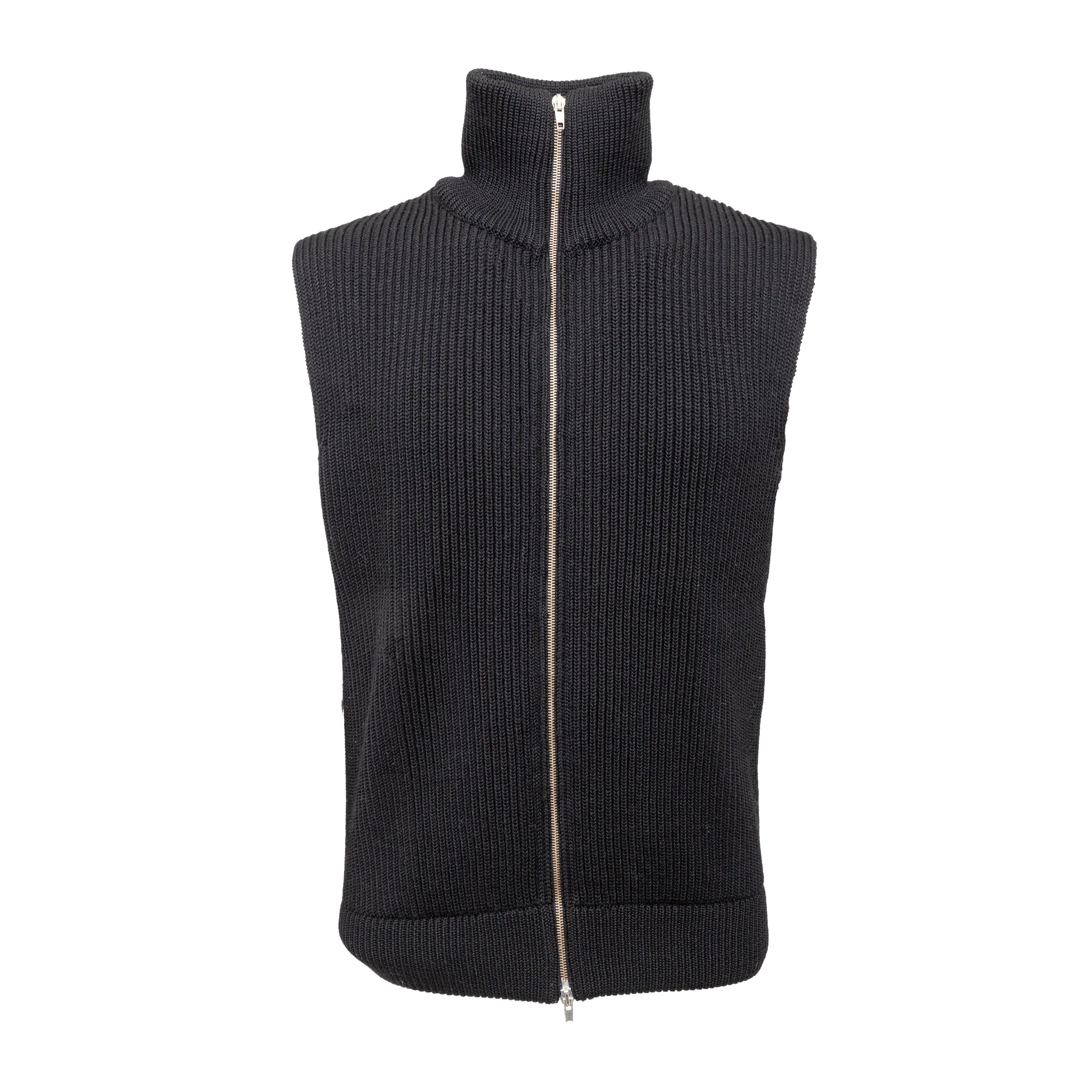 Expertly crafted and incredibly versatile, the Maison Margiela Zippered Knit Sweater Vest from the collection of 10 corso como is a must-have addition to any wardrobe. Made with 100% wool, this black knitted vest features a high neck and front